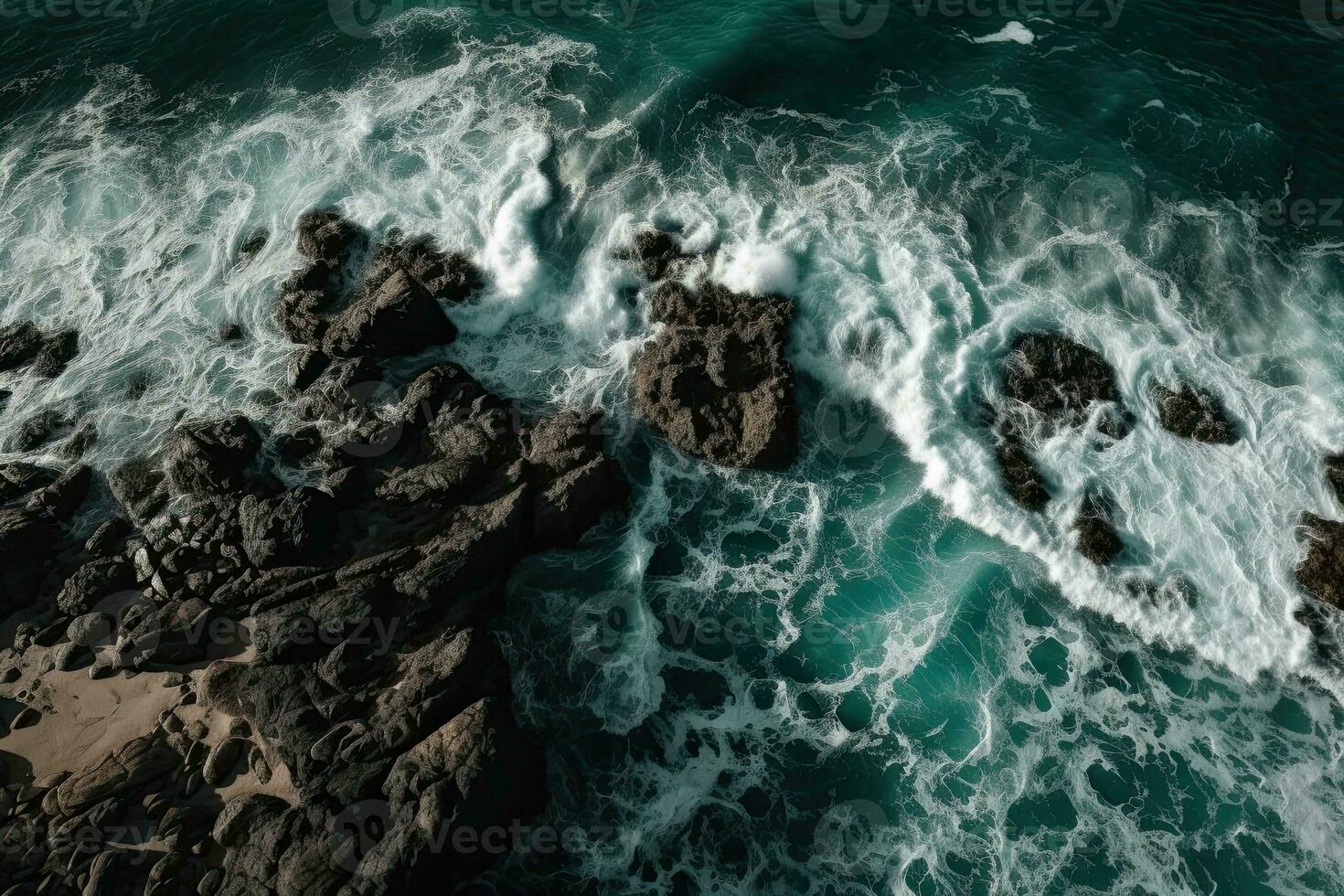 Aerial view of waves crashing against the rocks in the ocean. photo