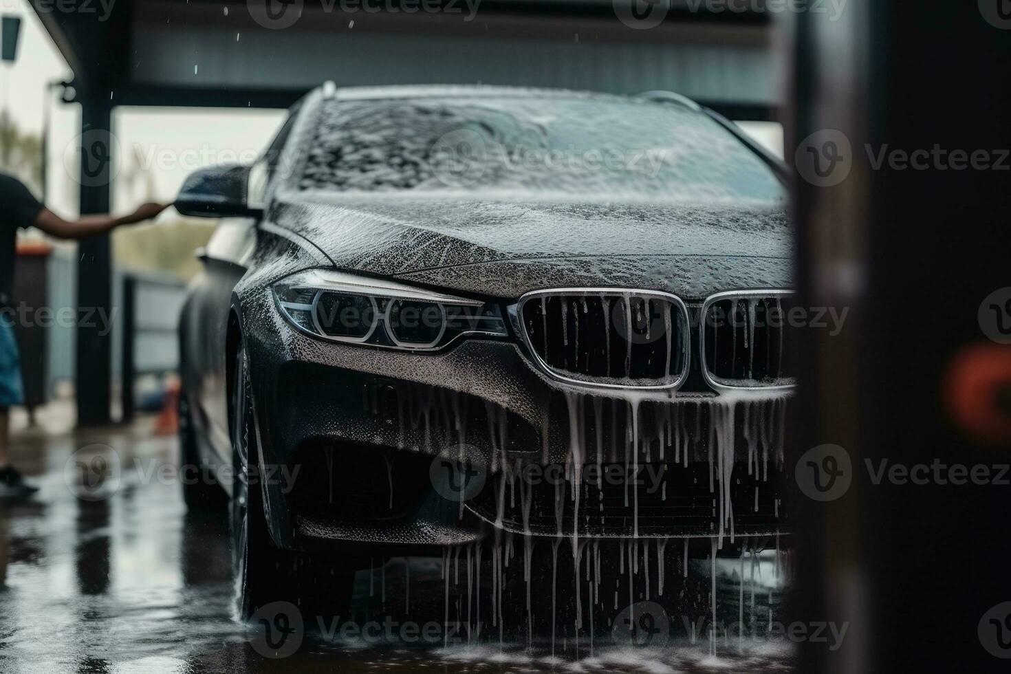 Close up man washing her car in a self - service car wash station. Car wash self - service photo