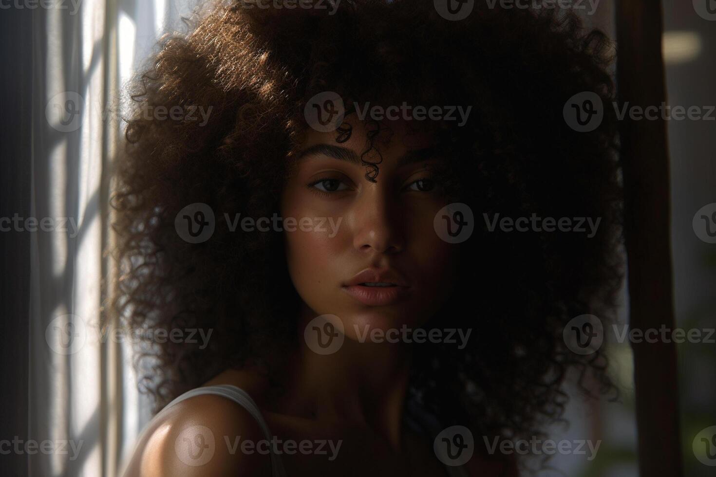 a black female with curly hair in the style of voluminous mass with photo