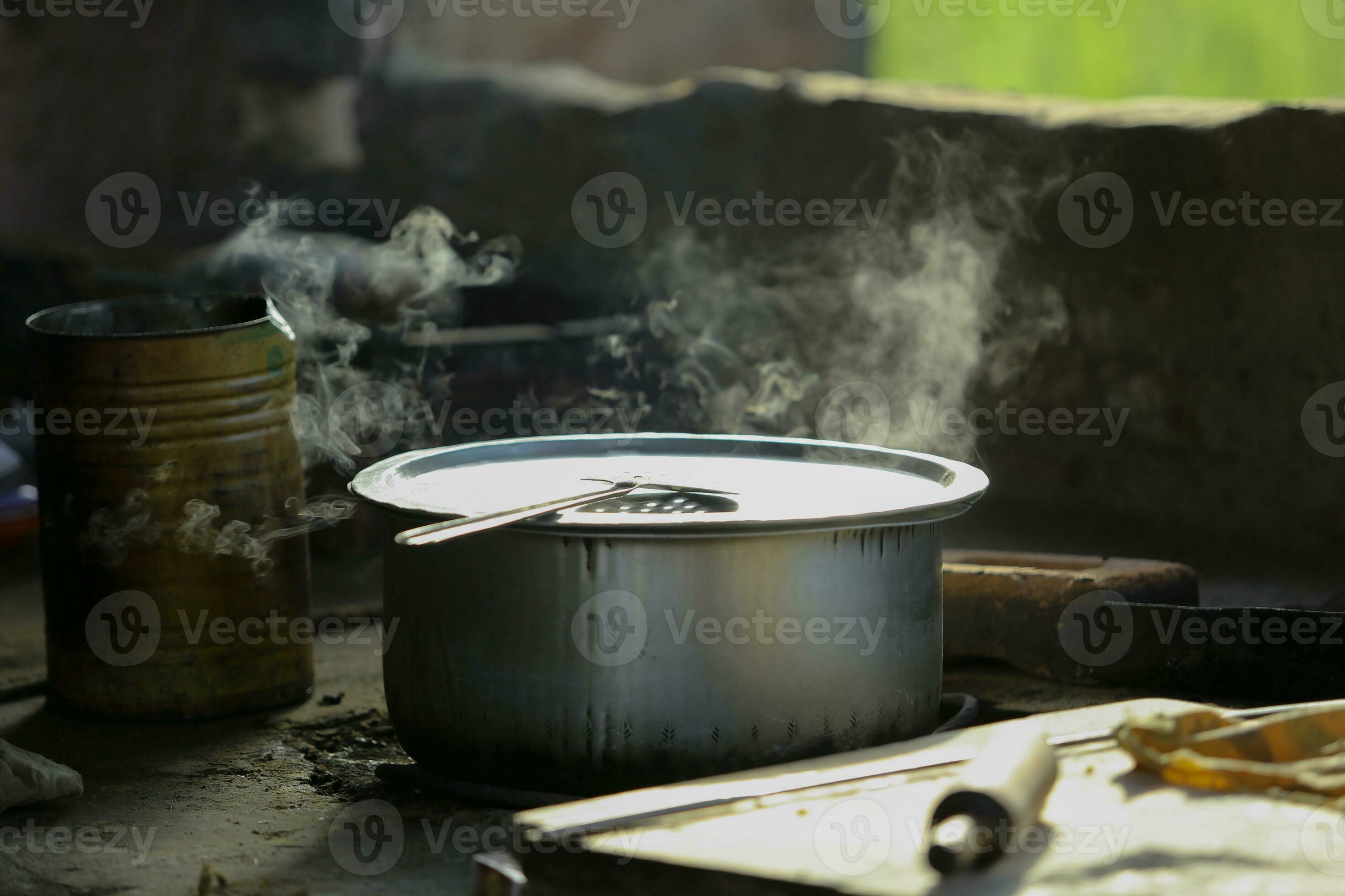 An old charred homemade cooker Smoke the cooker beside the charcoal