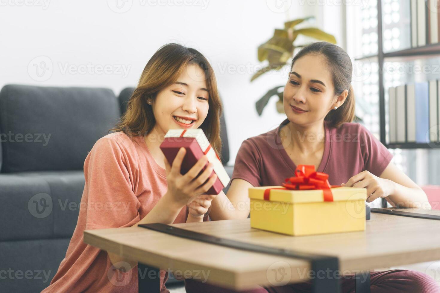 Southeast asian adult people couple give a gift box for anniversary or holidays event photo