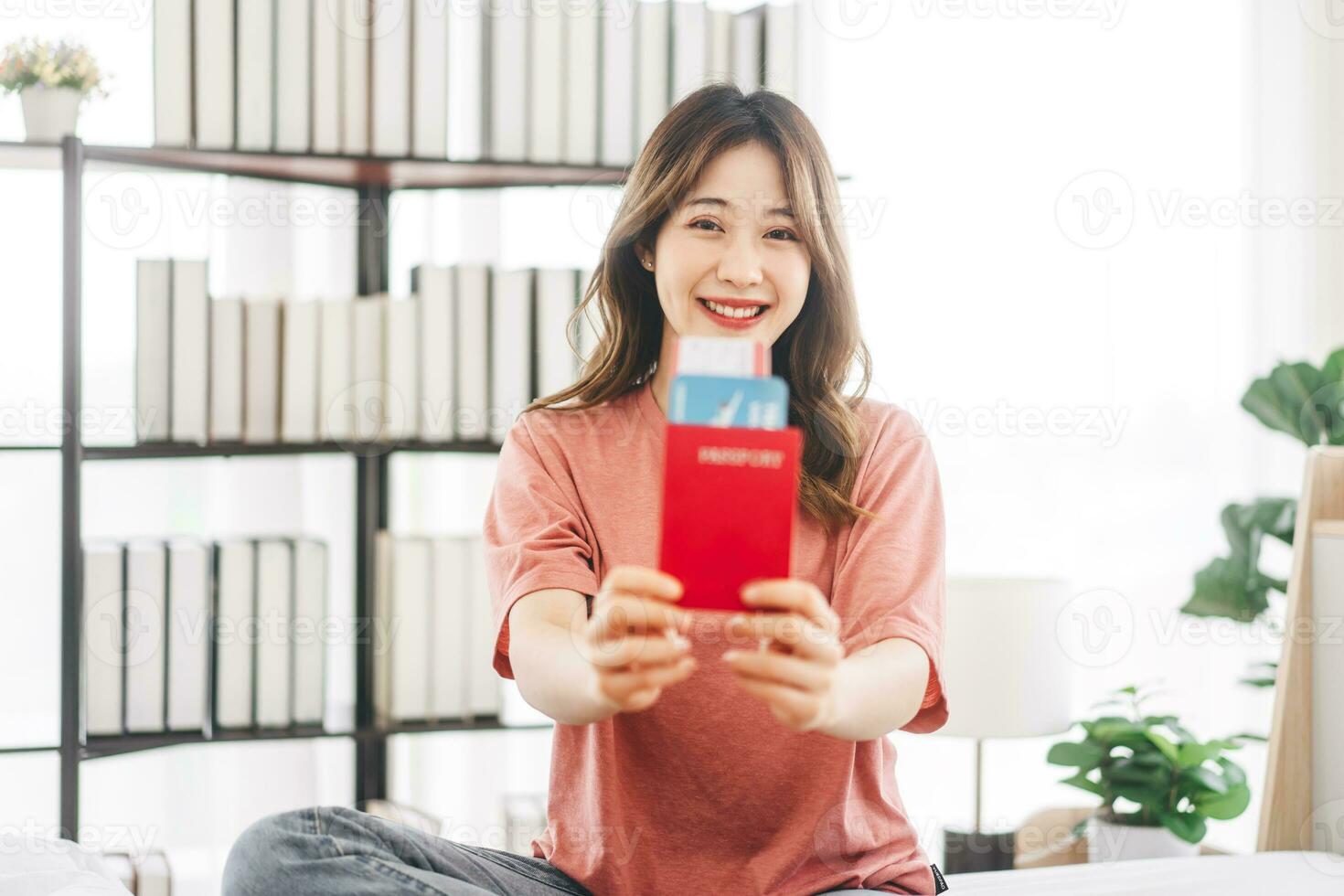 Young adult southeast asian woman showing passport ready for travel trip photo