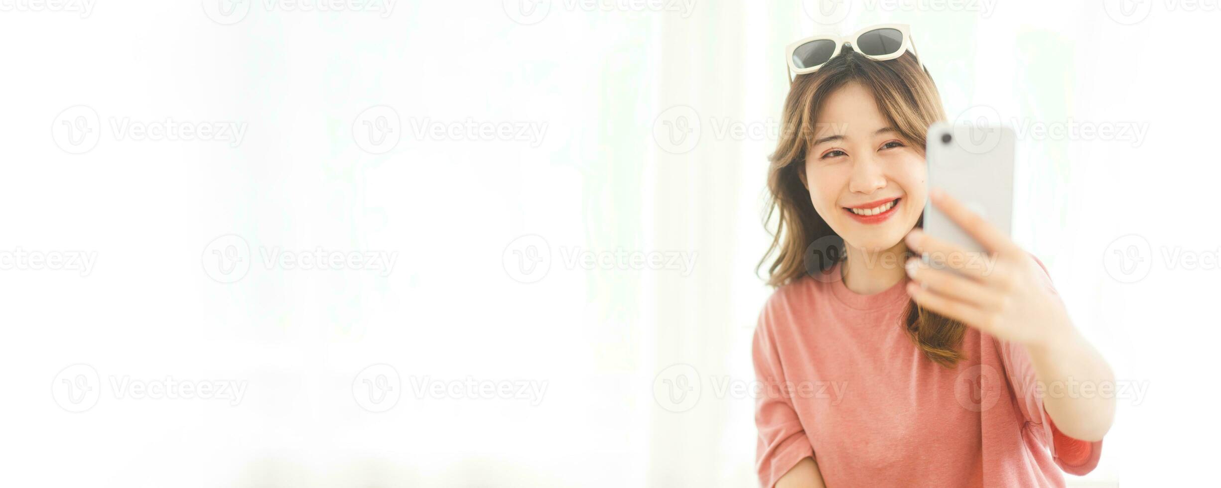 Asian woman using digital mobile phone for social message dating or shopping online in bedroom photo