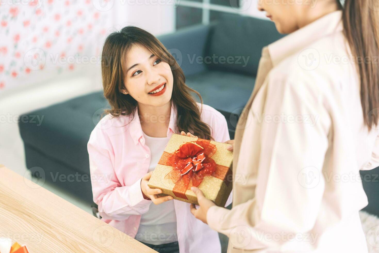 Southeast asian adult people couple give a gift box for anniversary or holidays event photo