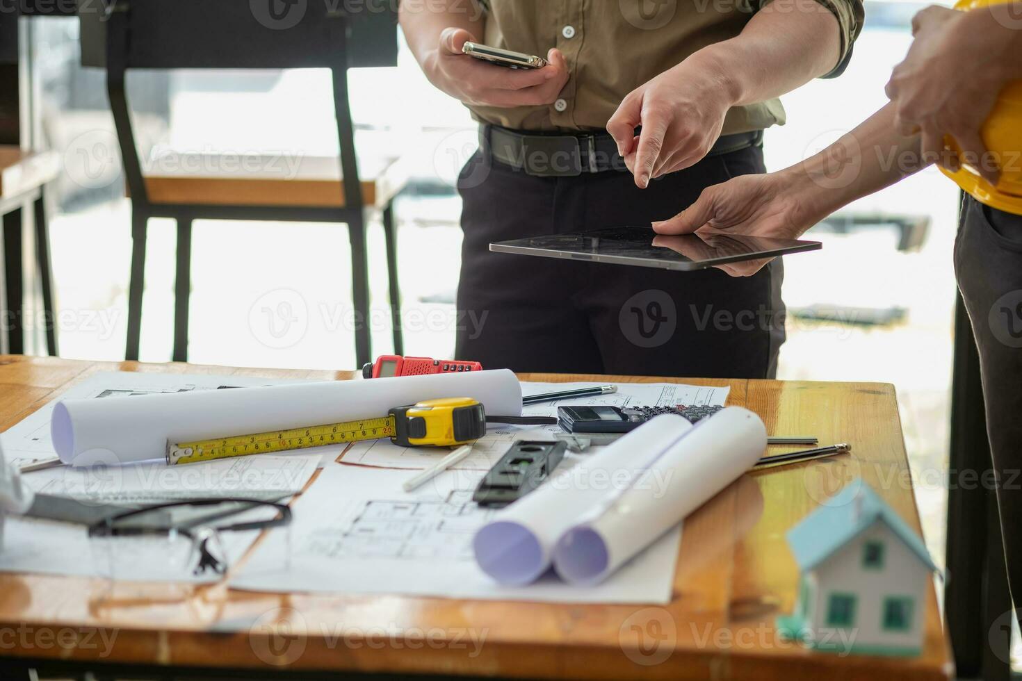 Asian engineers brainstorm and measure to document cost estimates and write floor plans for architectural and engineering designs for houses and buildings. photo