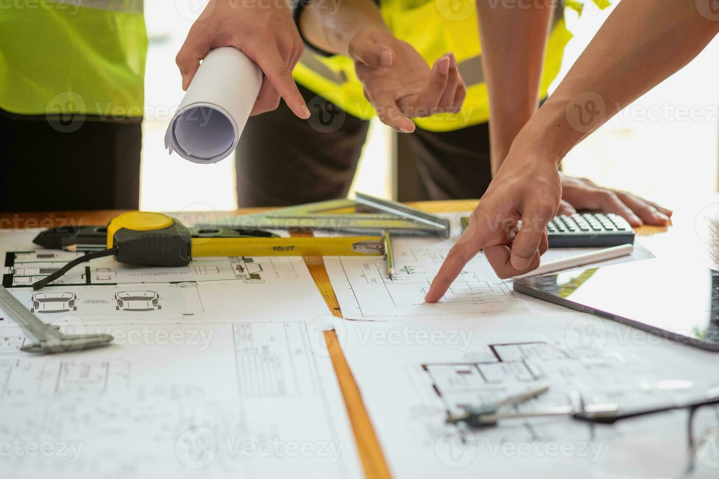 Asian engineers brainstorm and measure to document cost estimates and write floor plans for architectural and engineering designs for houses and buildings. photo