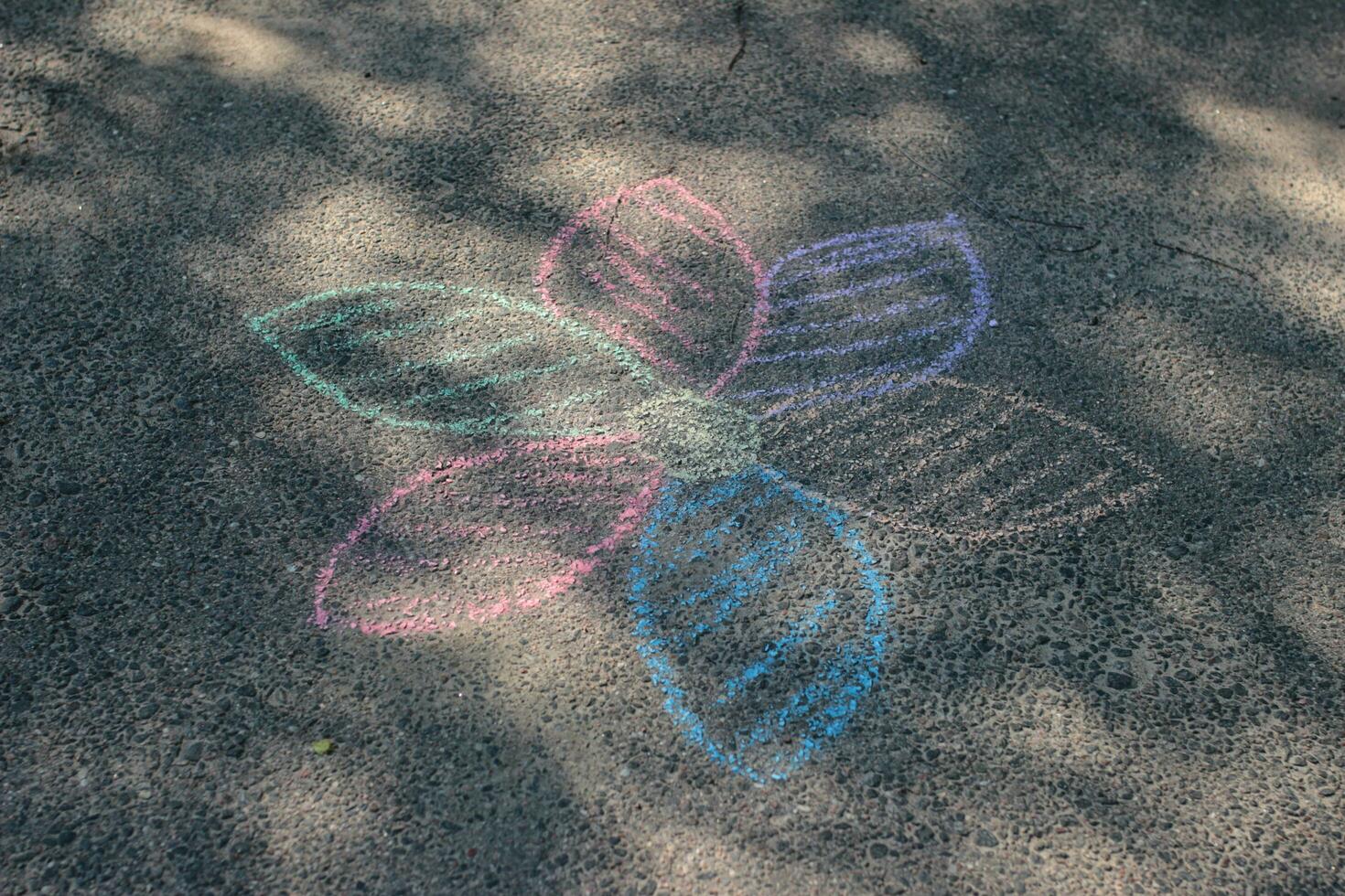 Children's drawing on the pavement. Multicolored chalk photo