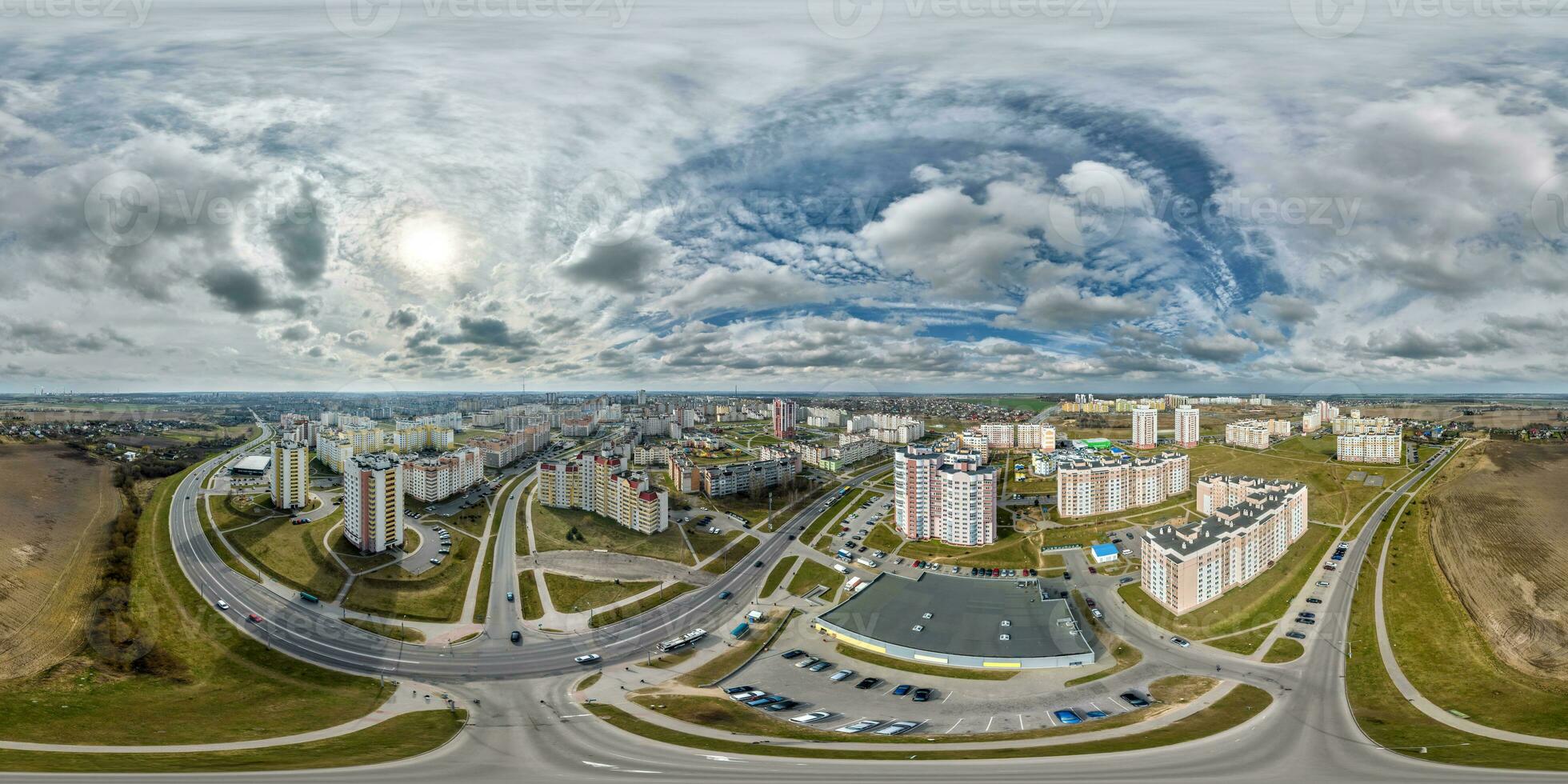 aerial seamless spherical hdri 360 panorama view above road junction with traffic in residential complex with high-rise buildings in town in equirectangular projection. photo