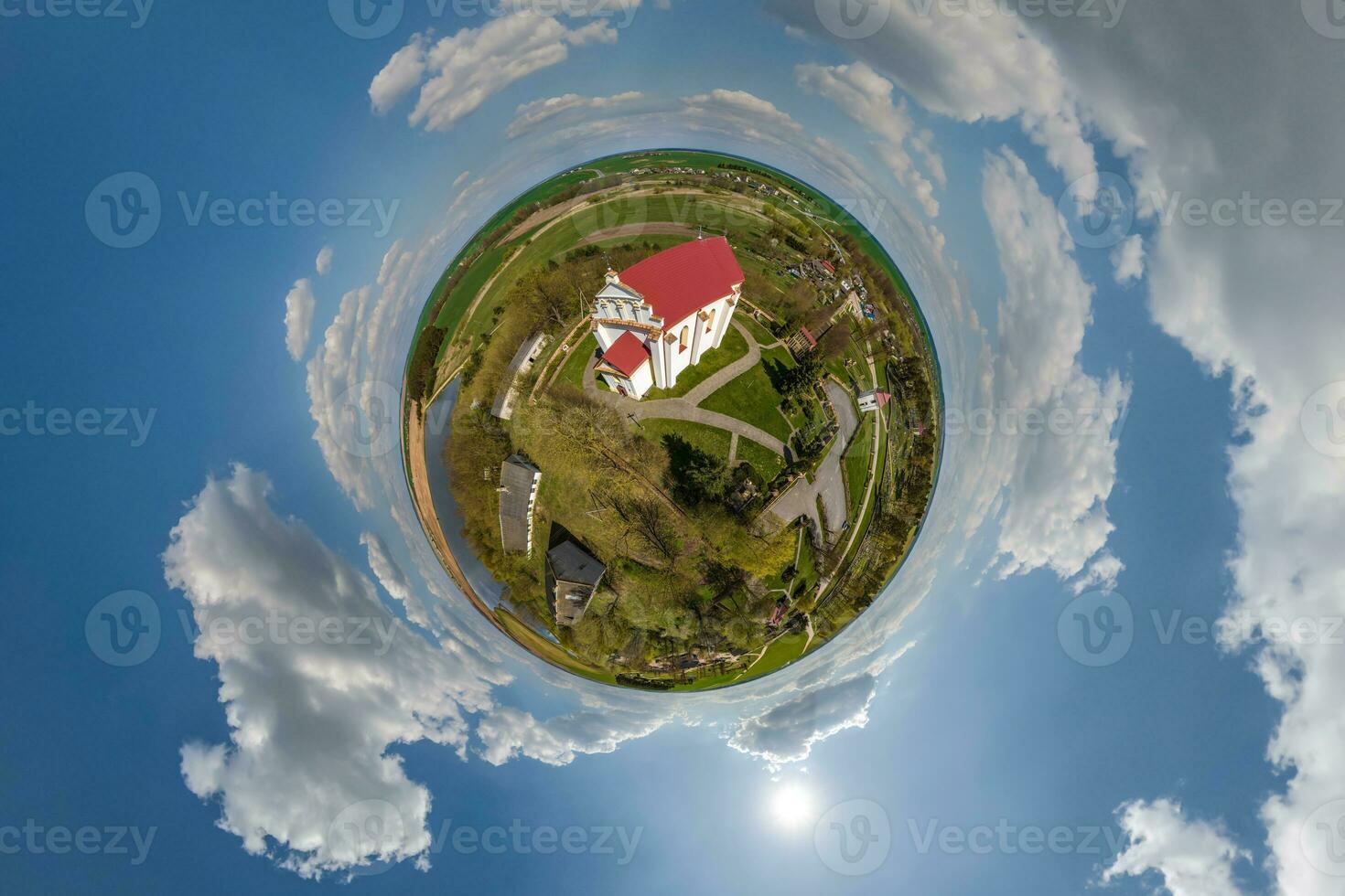 little planet transformation of spherical panorama 360 degrees overlooking church in center of globe in blue sky. Spherical abstract aerial view with curvature of space. photo