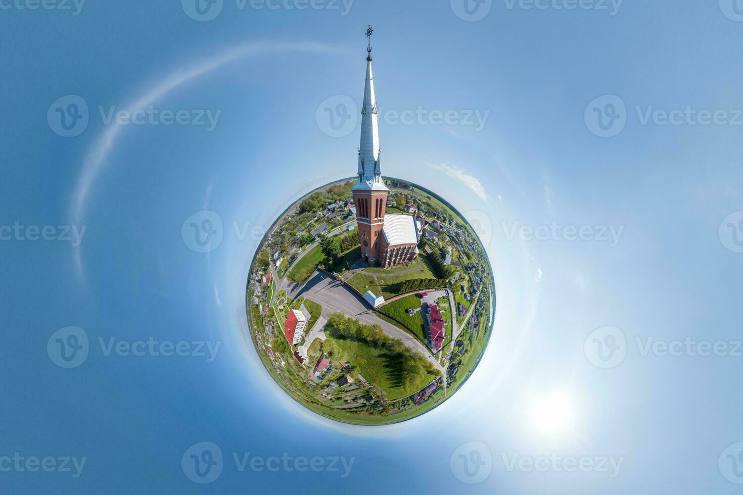 little planet transformation of spherical panorama 360 degrees overlooking church in center of globe in blue sky. Spherical abstract aerial view with curvature of space. photo