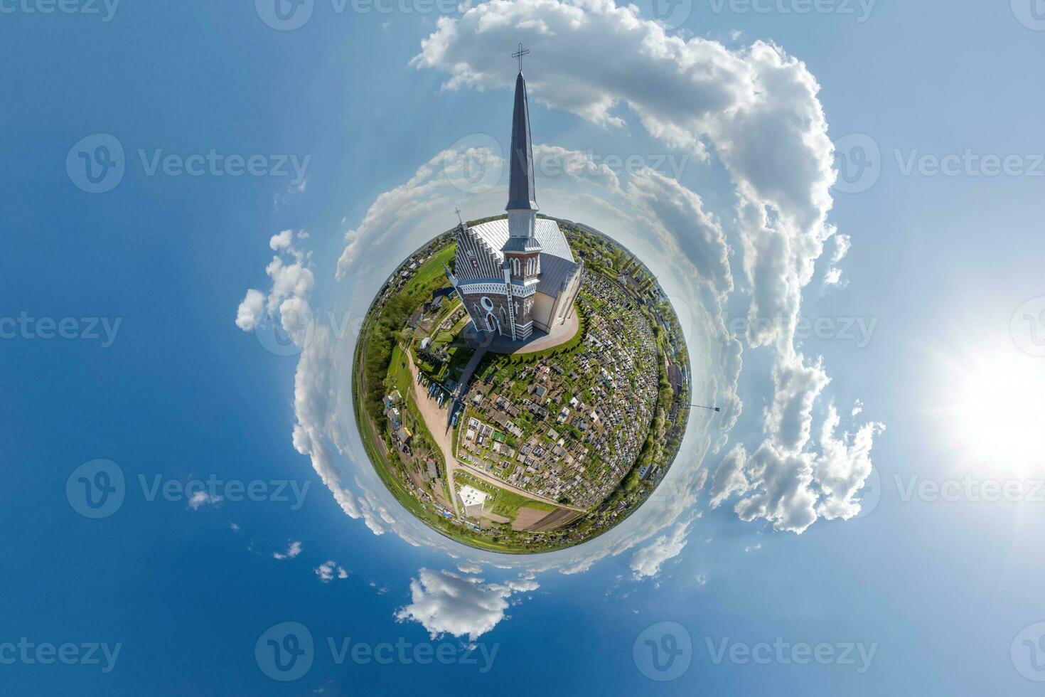 little planet transformation of spherical panorama 360 degrees overlooking church in center of globe in blue sky. Spherical abstract aerial view with curvature of space. photo