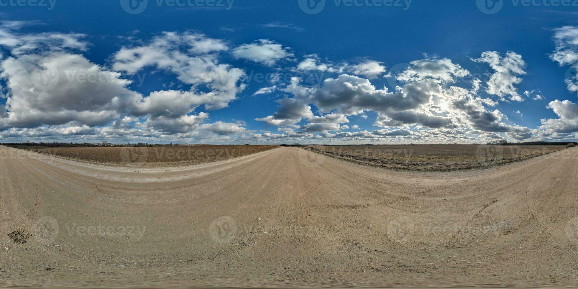 spherical 360 hdri panorama on gravel road with clouds and sun on blue sky in equirectangular seamless projection, use as sky replacement in drone panoramas, game development as sky dome or VR content photo