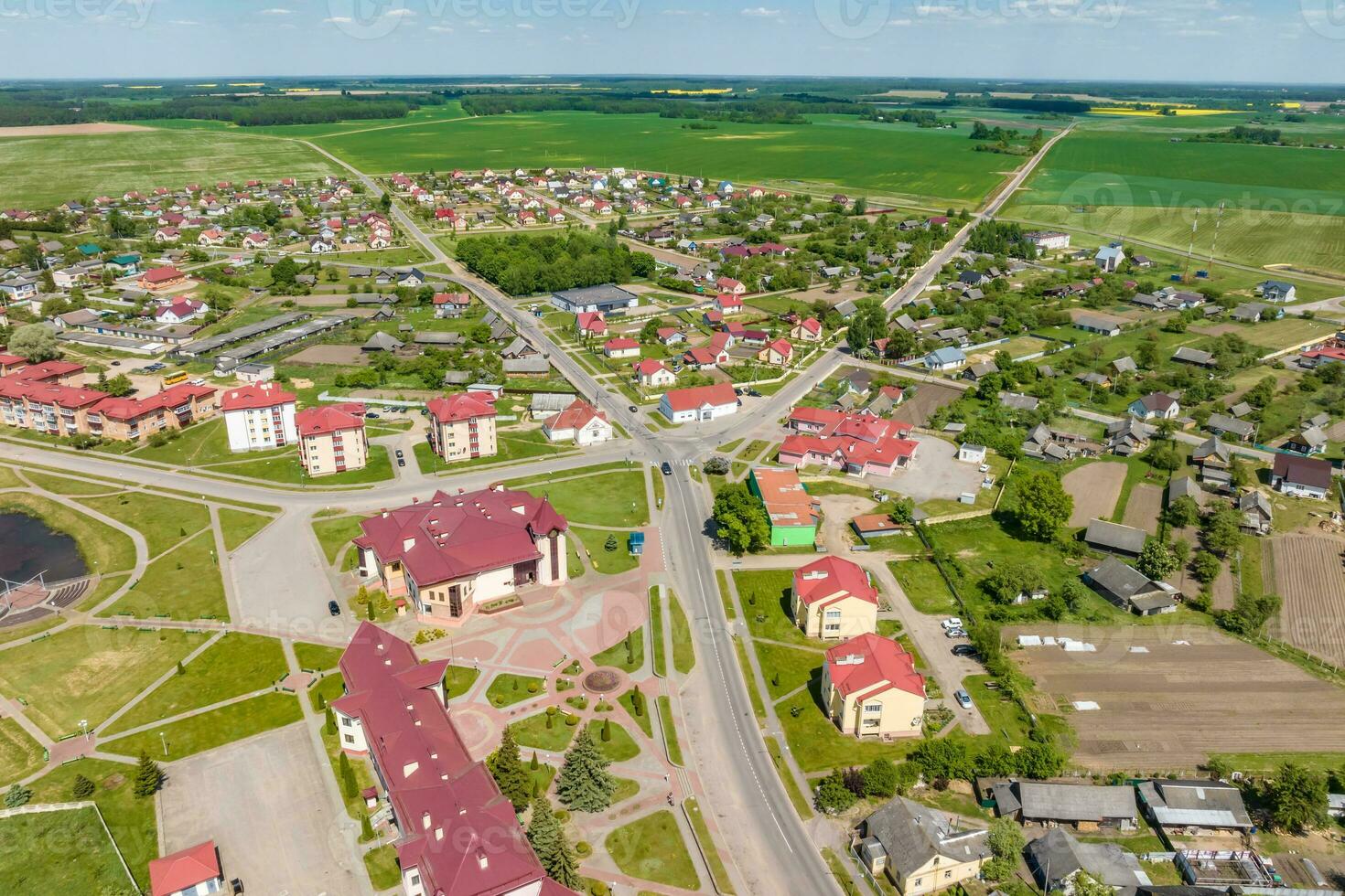 panoramic aerial view of a small urban-type settlement with red roofs photo