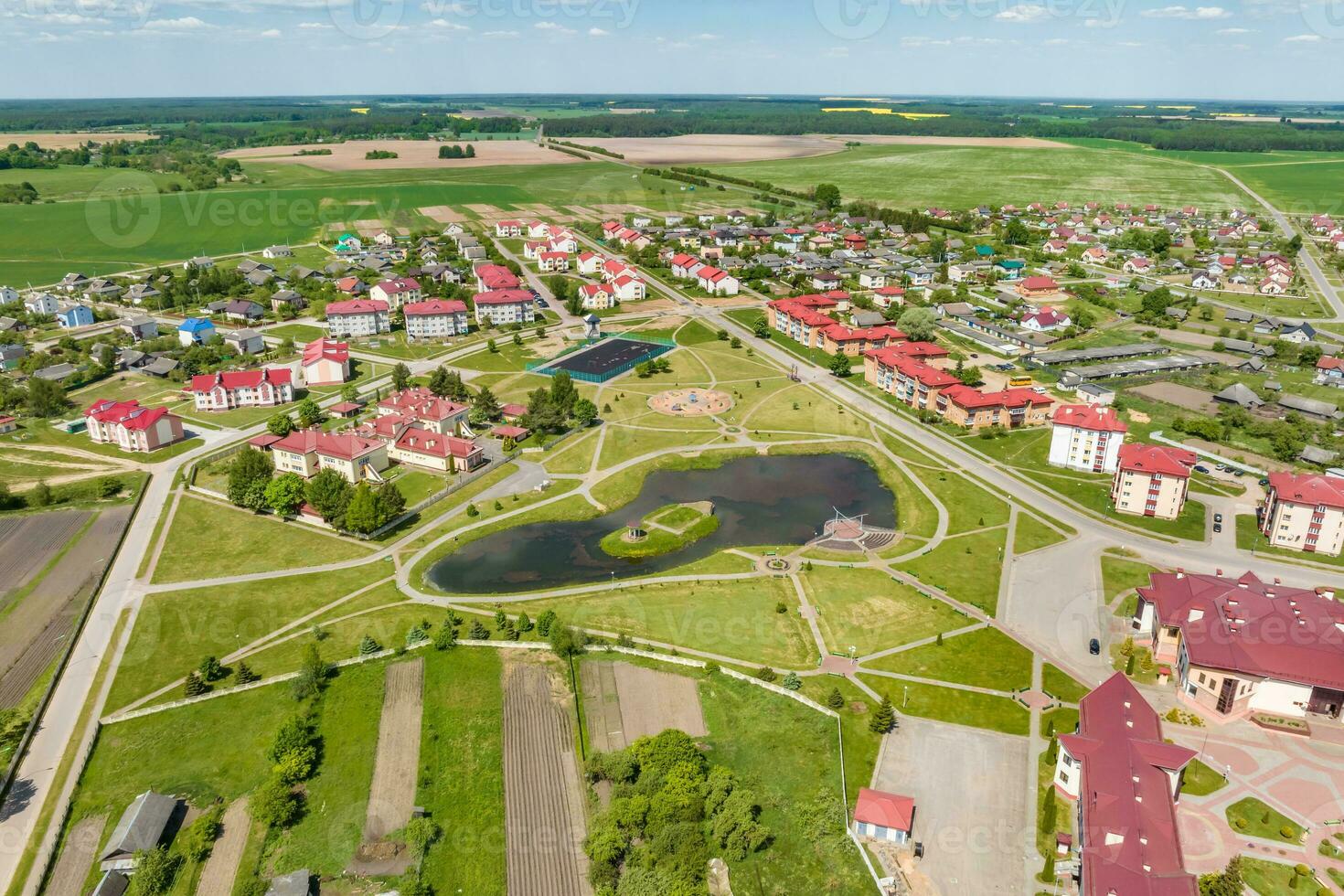 panoramic aerial view of a small urban-type settlement with red roofs photo