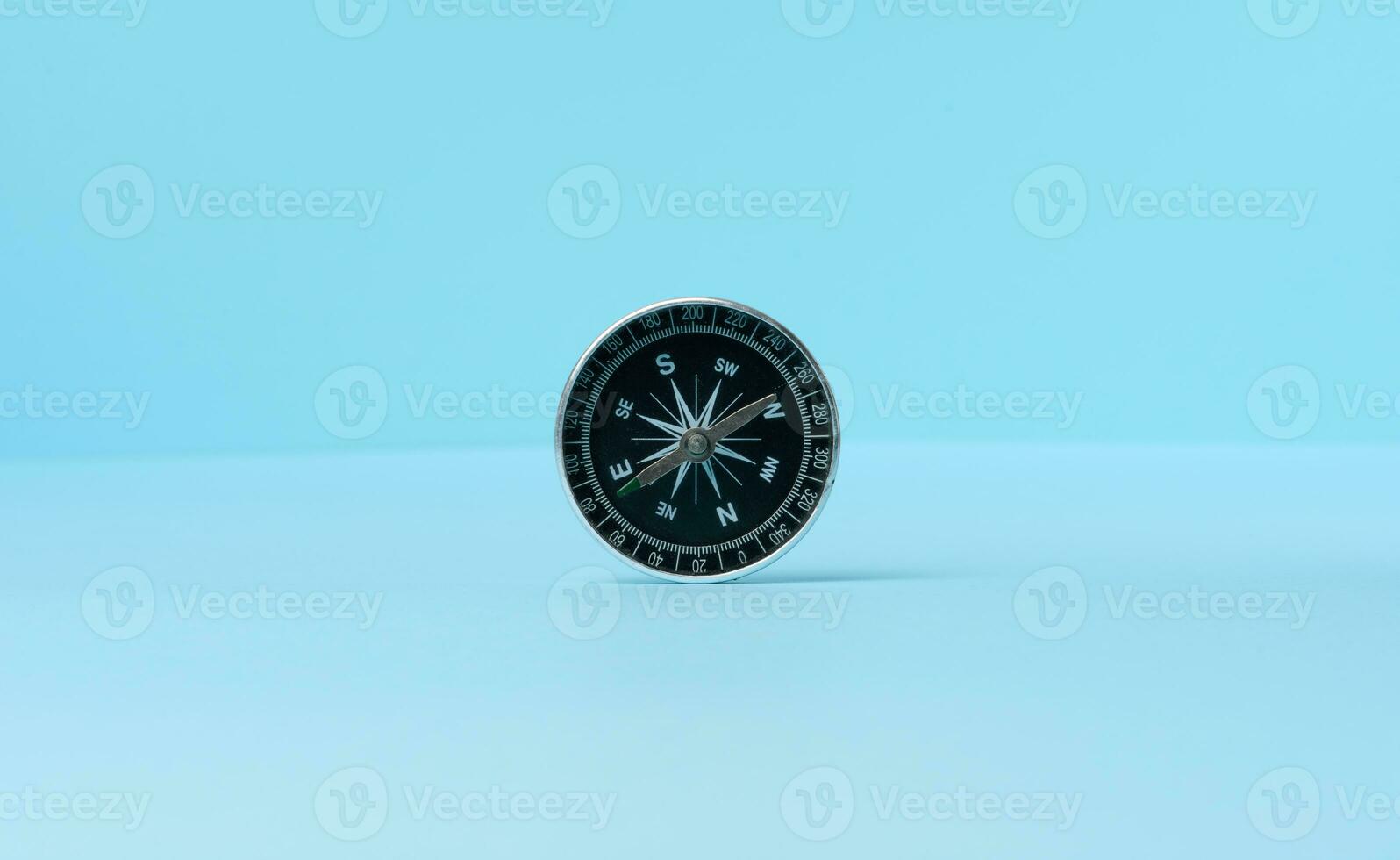 Round compass on a blue background photo