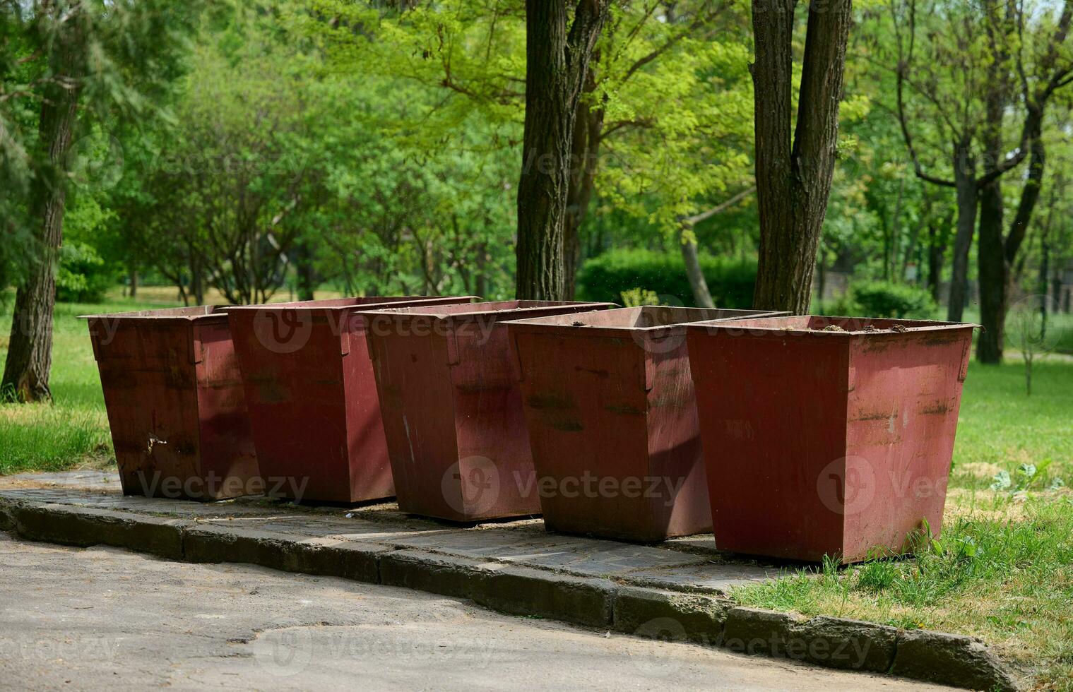 Empty metal trash cans in the park photo