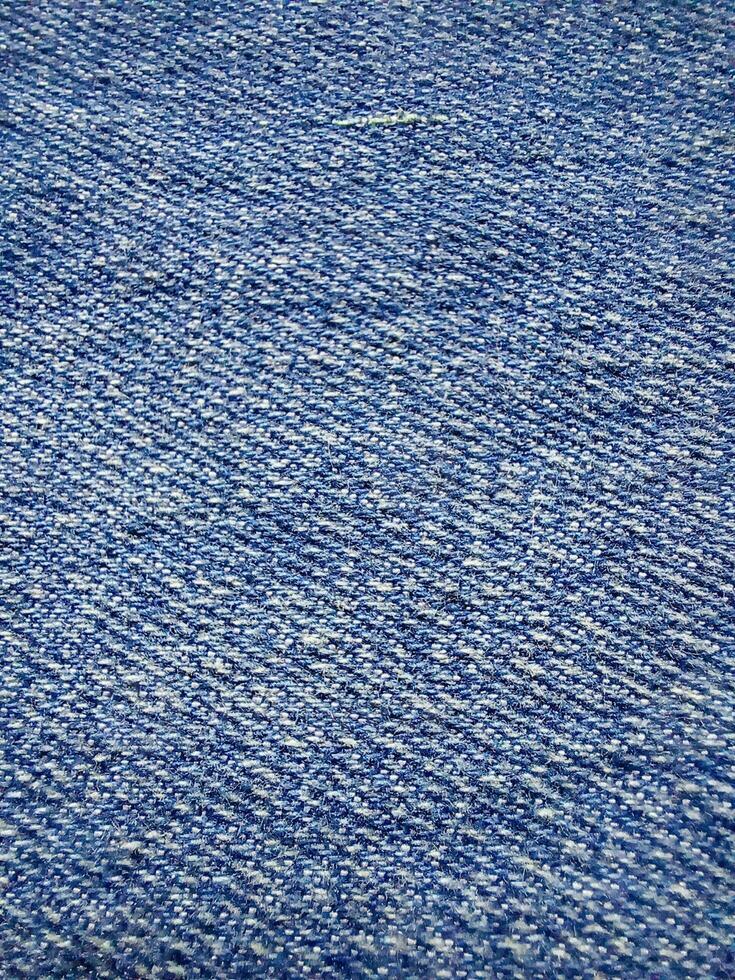 Texture of blue jeans, details Close-up of the denim. photo