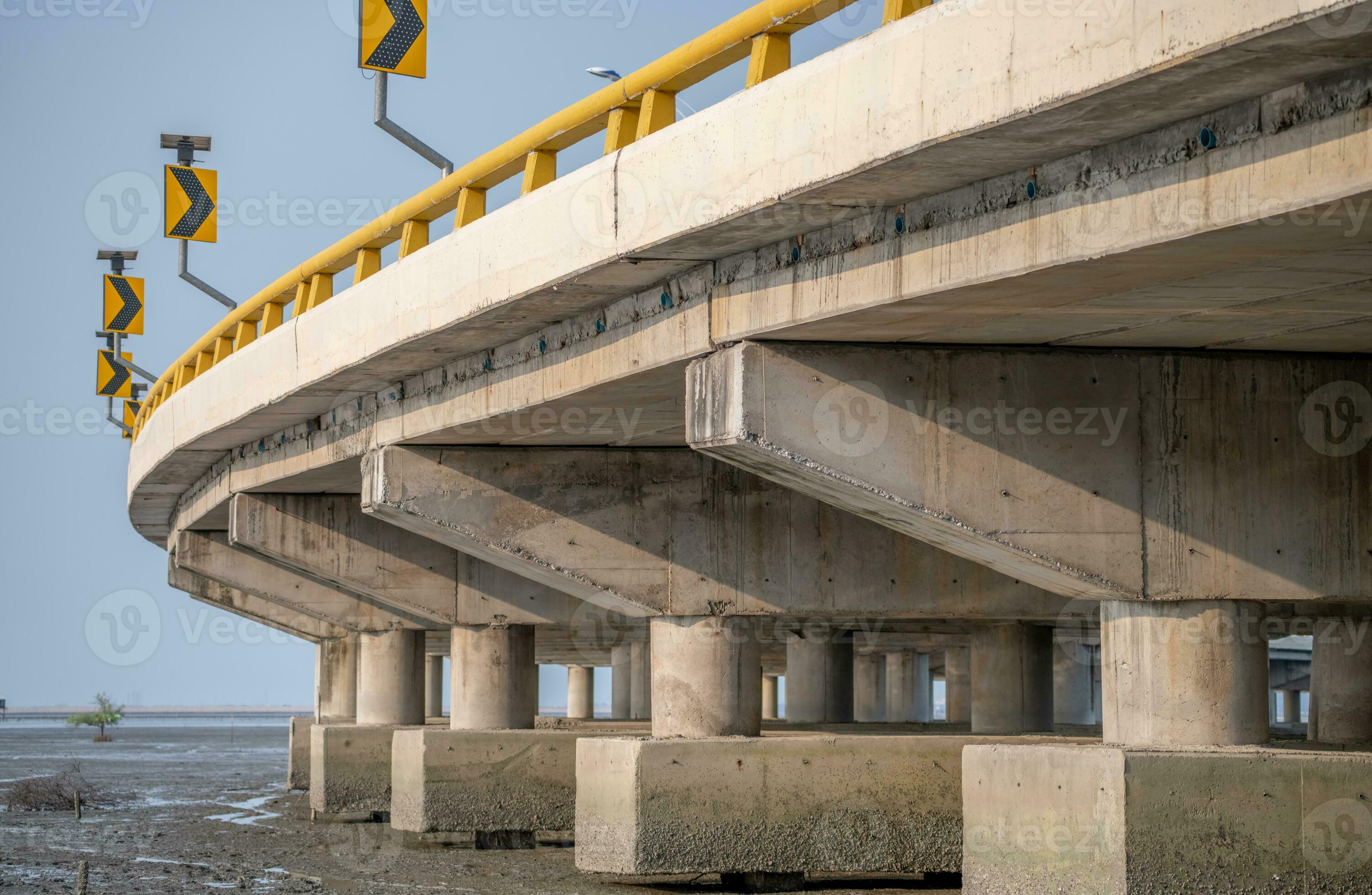 Structure of reinforced concrete bridge along the sea. Bottom view of
