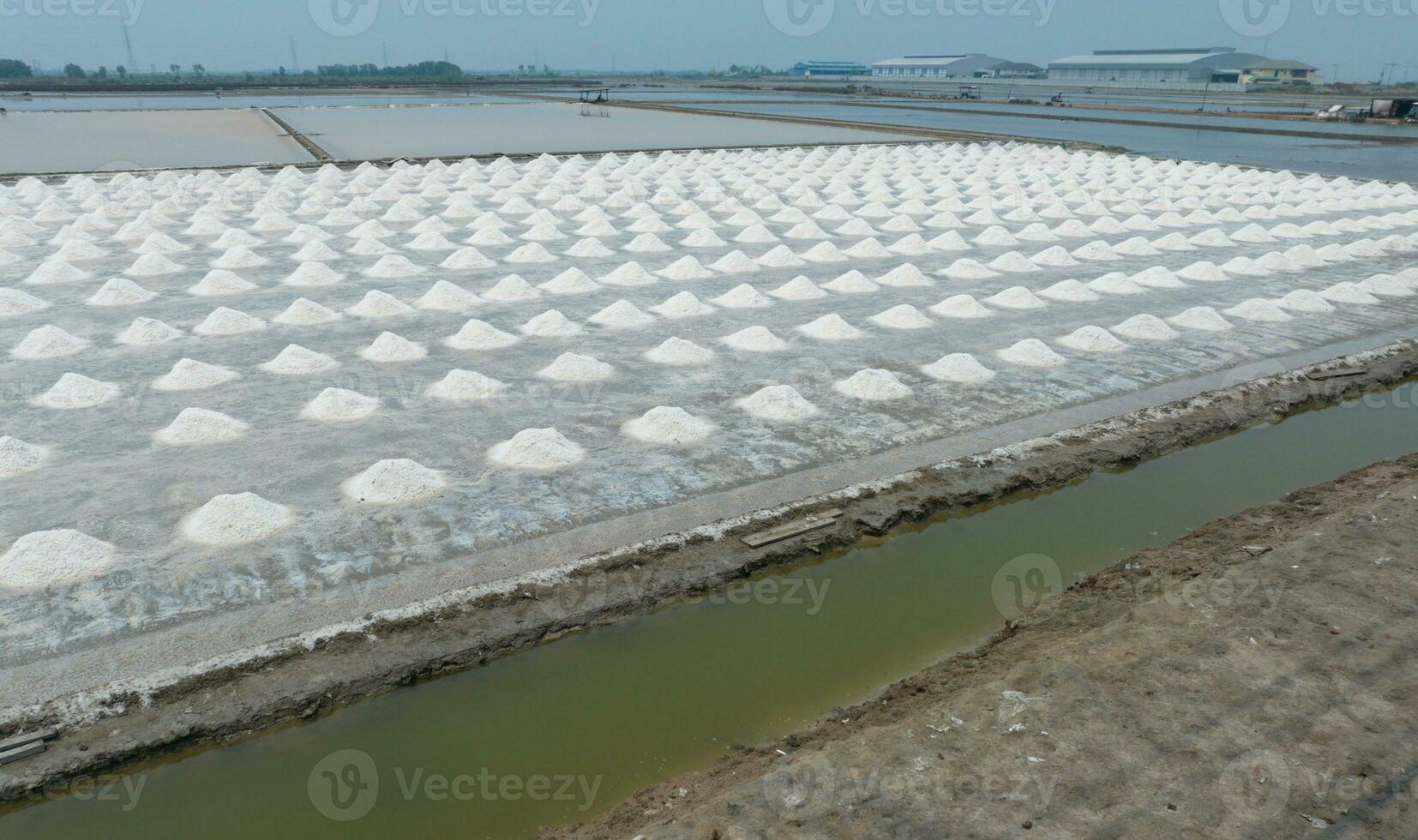 Aerial view of sea salt farm. Pile of brine salt. Raw material of salt