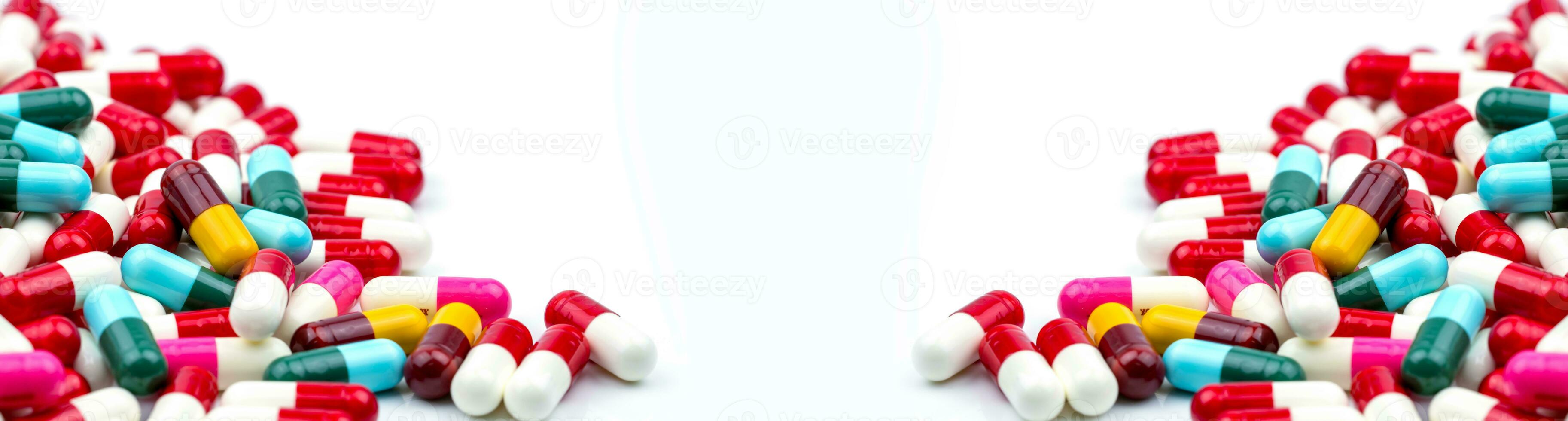 Frame of colorful antibiotic capsule pills. Pile of antibiotic capsule pills. Antibiotic drug resistance concept. Prescription drug. Pharmaceutical industry. Healthcare and medicine. Medical care. photo
