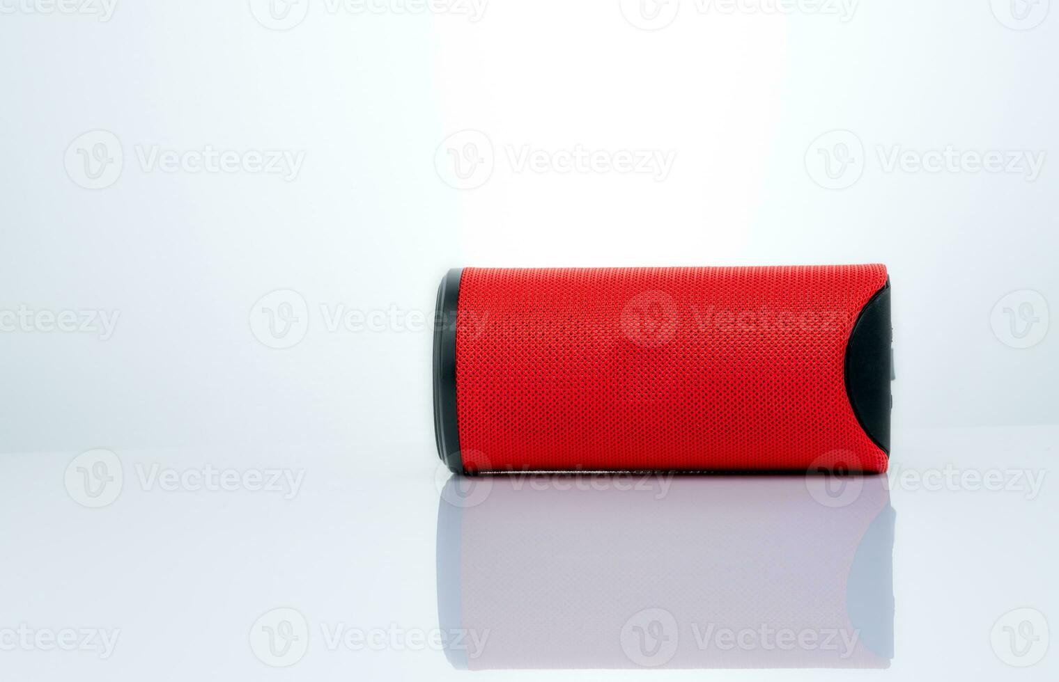 Wireless portable speaker isolated on white background. Red Digital portable speakers. Small sound music box speaker. Modern design mini portable Wireless loudspeaker. Digital wireless technology. photo