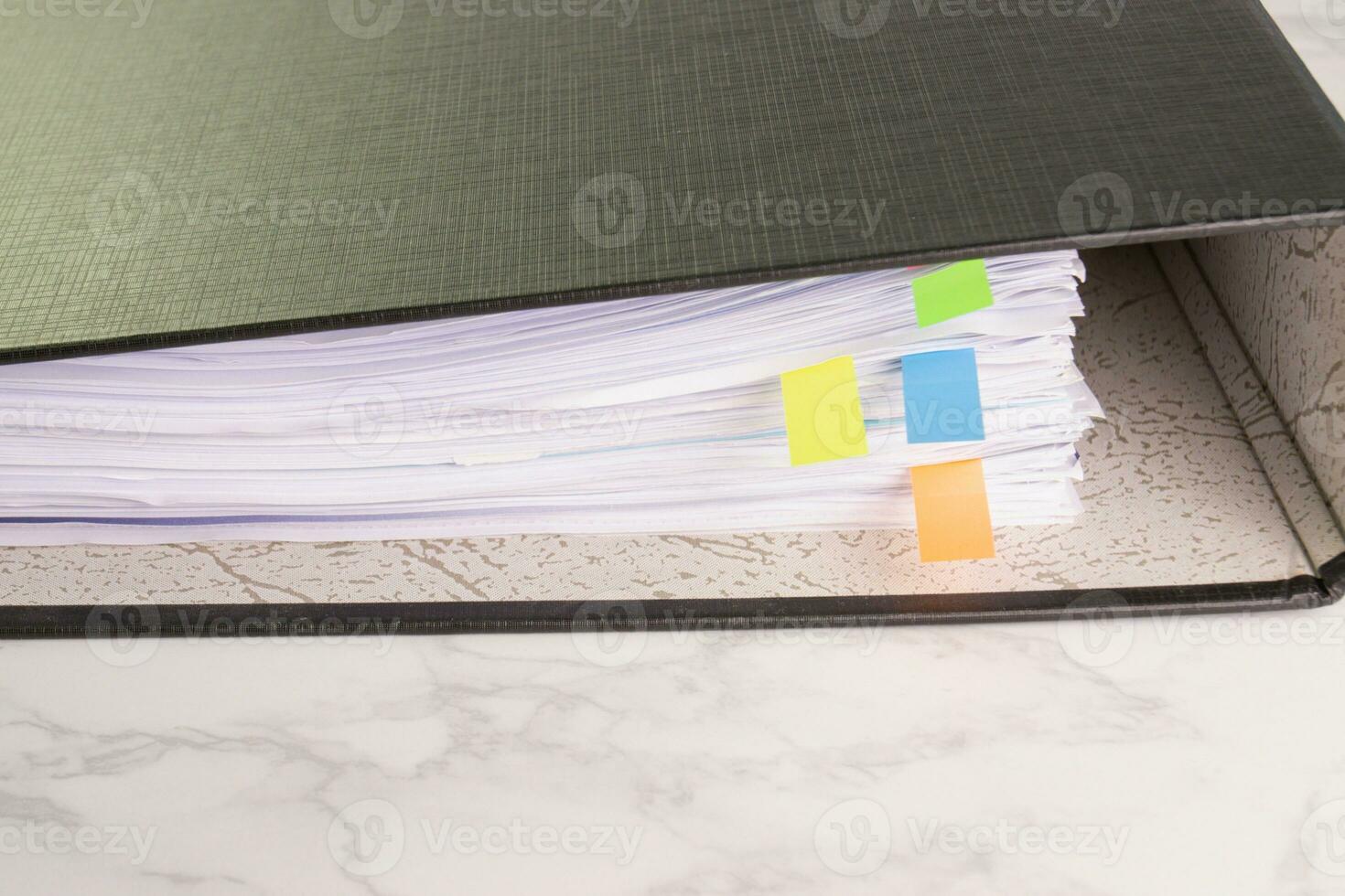 white paper stack in folder file for a business contract, income, expenses photo