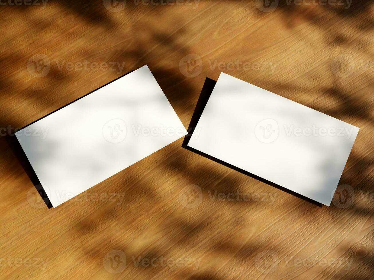 Clean minimal business card mockup with the leaves shadow on wood table background photo