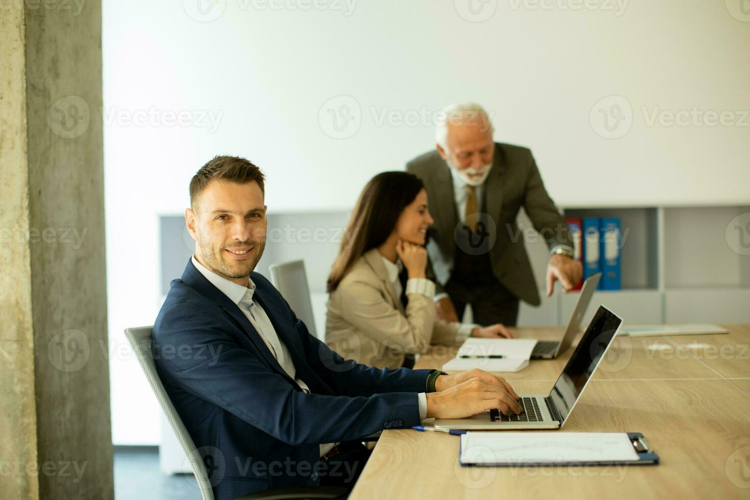 Young business man using laptop computer in the office photo