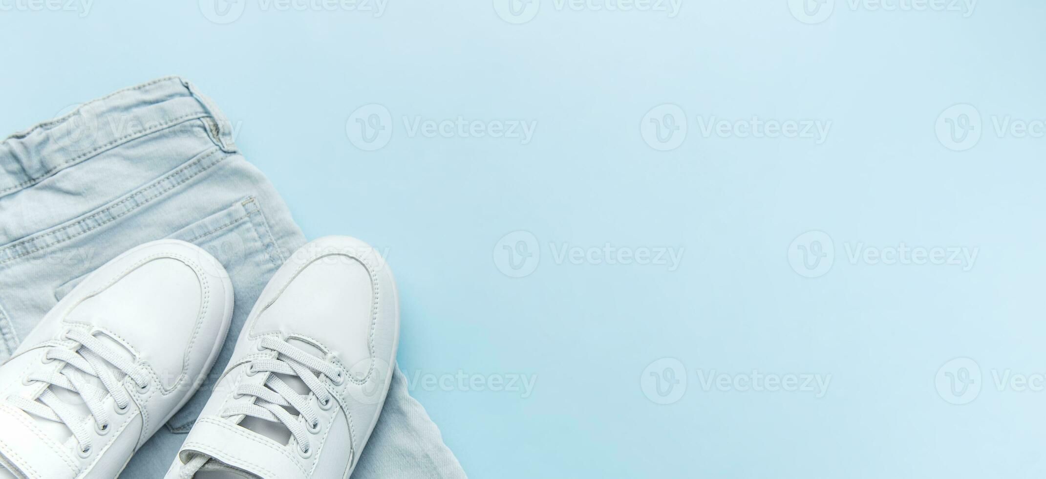 Banner Set of children jeans and white sneakers, casual style. photo