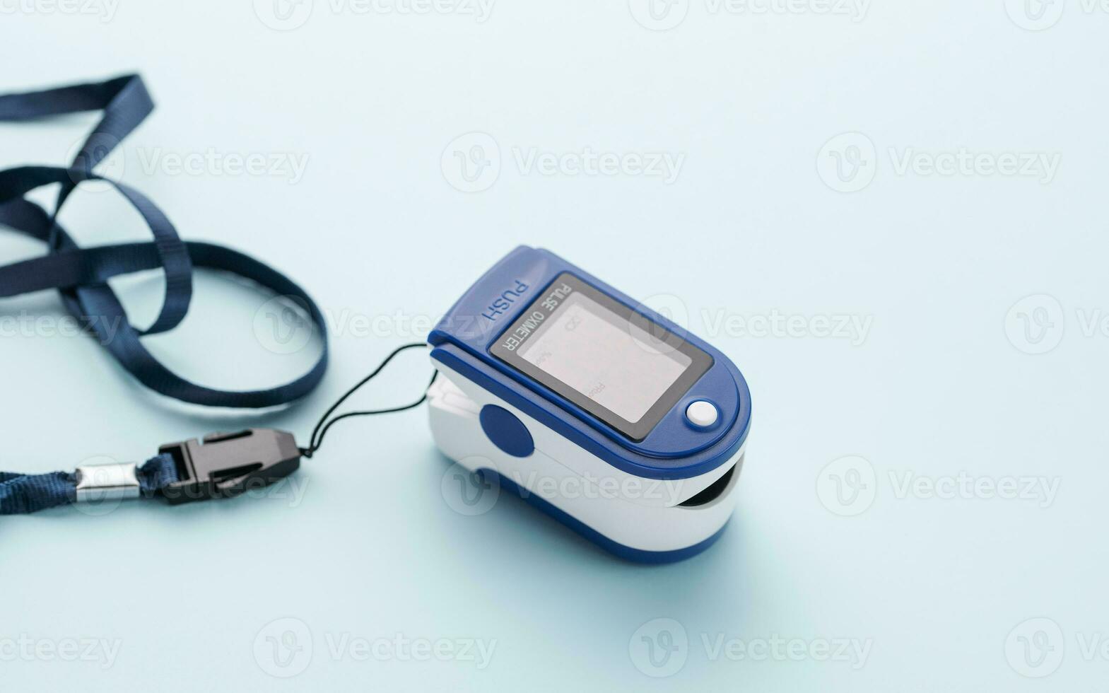 Pulse oximeter on blue background photo