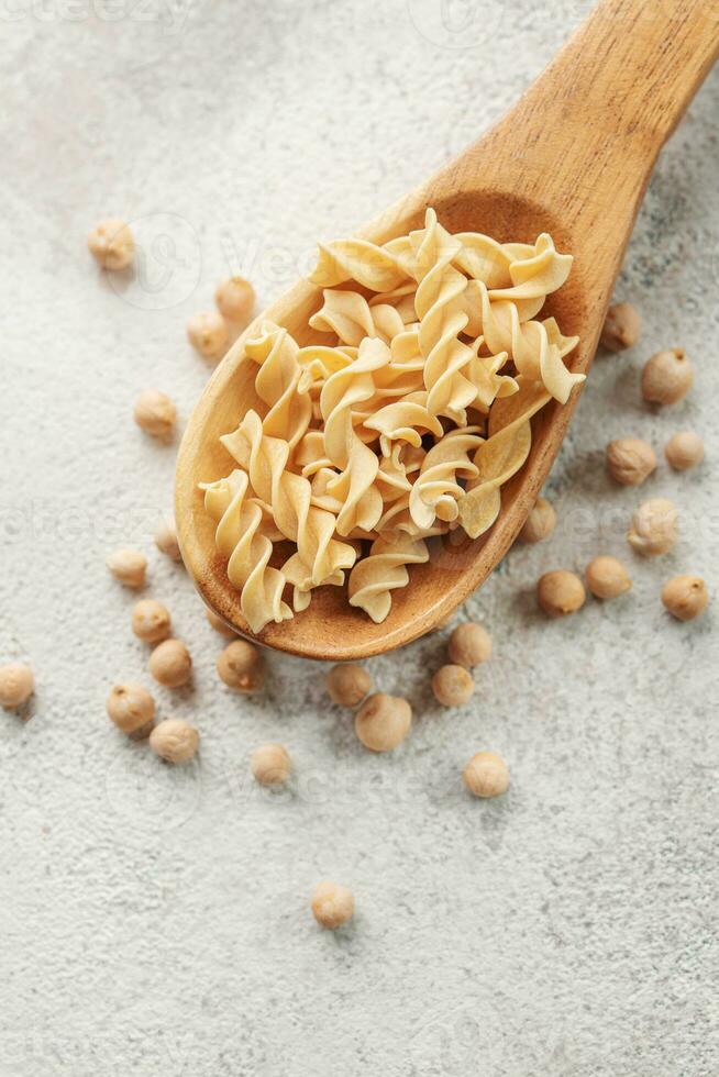 Chickpea bean fusilli pasta on a gray concrete background. photo