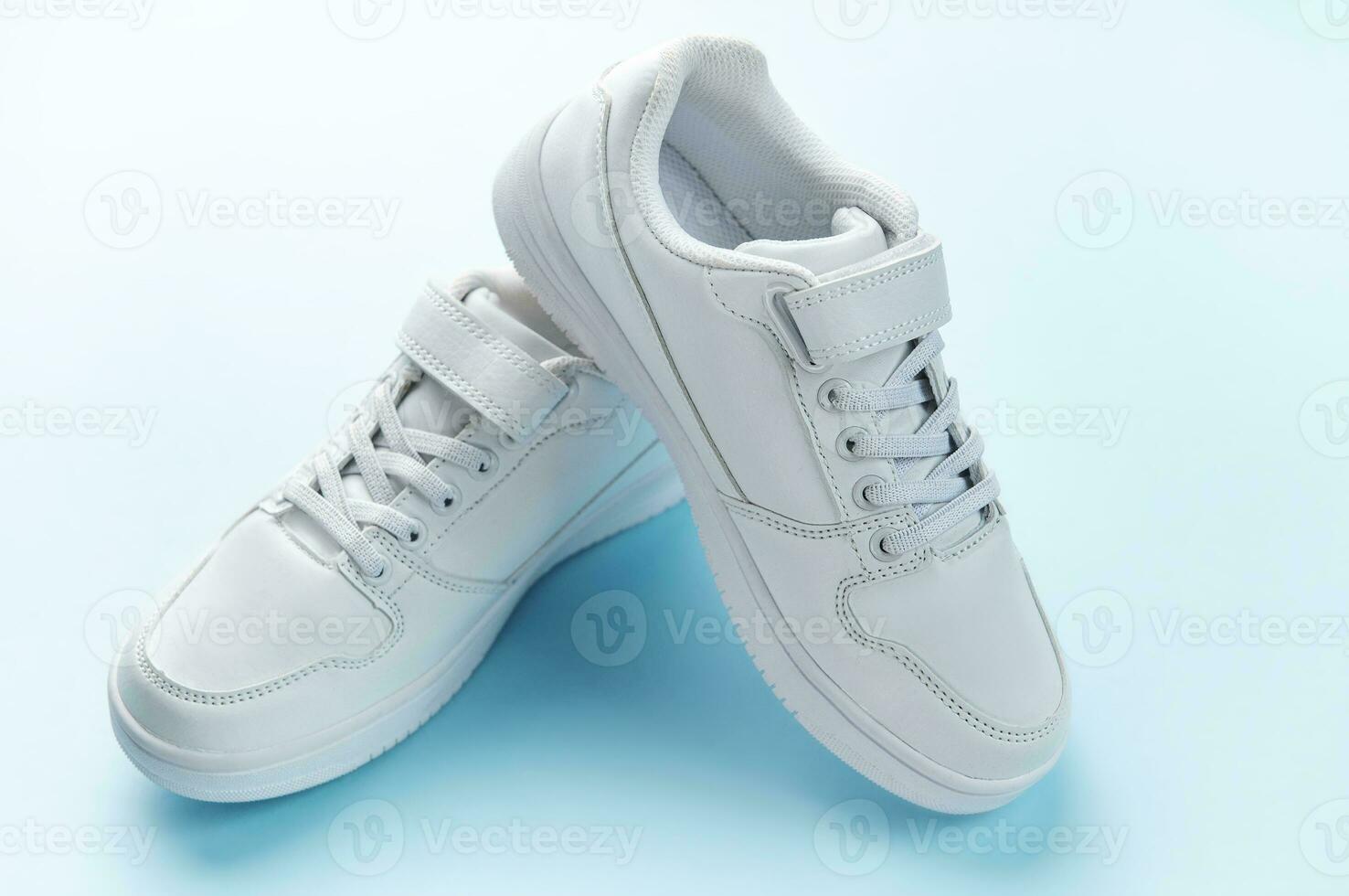 White sneakers on a blue background. photo