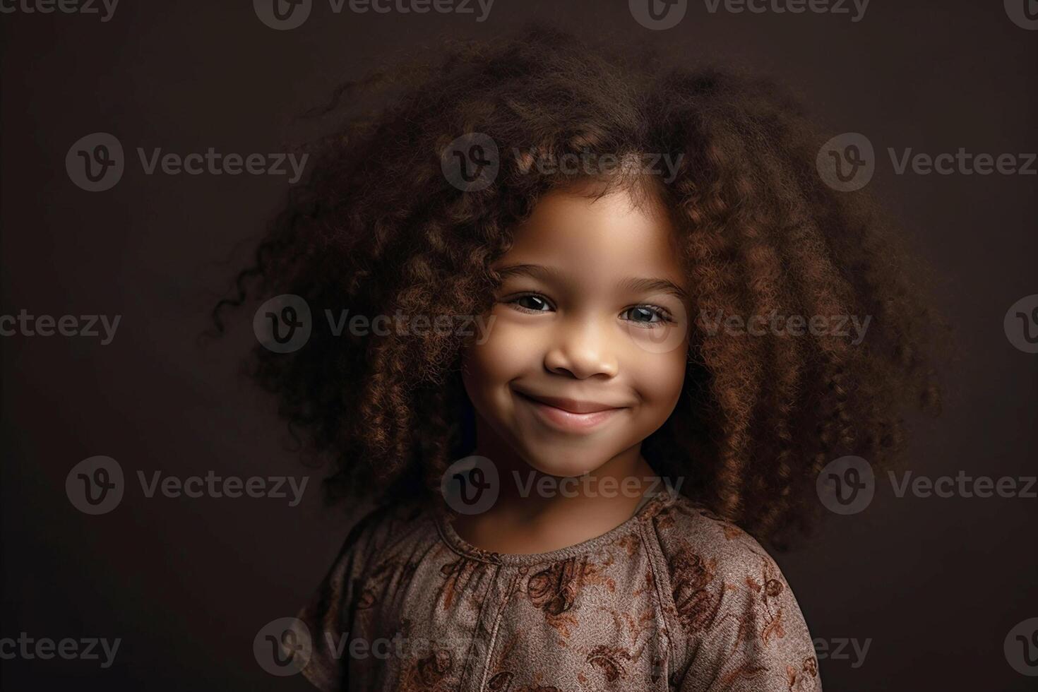 Portrait of a smiling dark-skinned girl with long, curly hair. photo