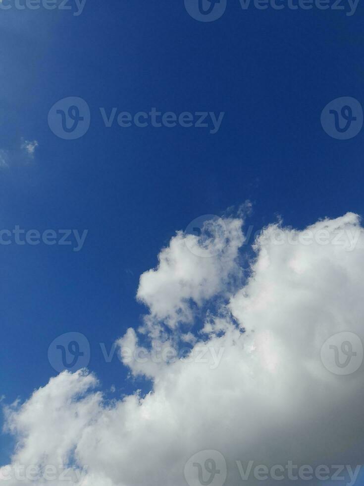 Beautiful white clouds on deep blue sky background. Large bright soft fluffy clouds are cover the entire blue sky. photo