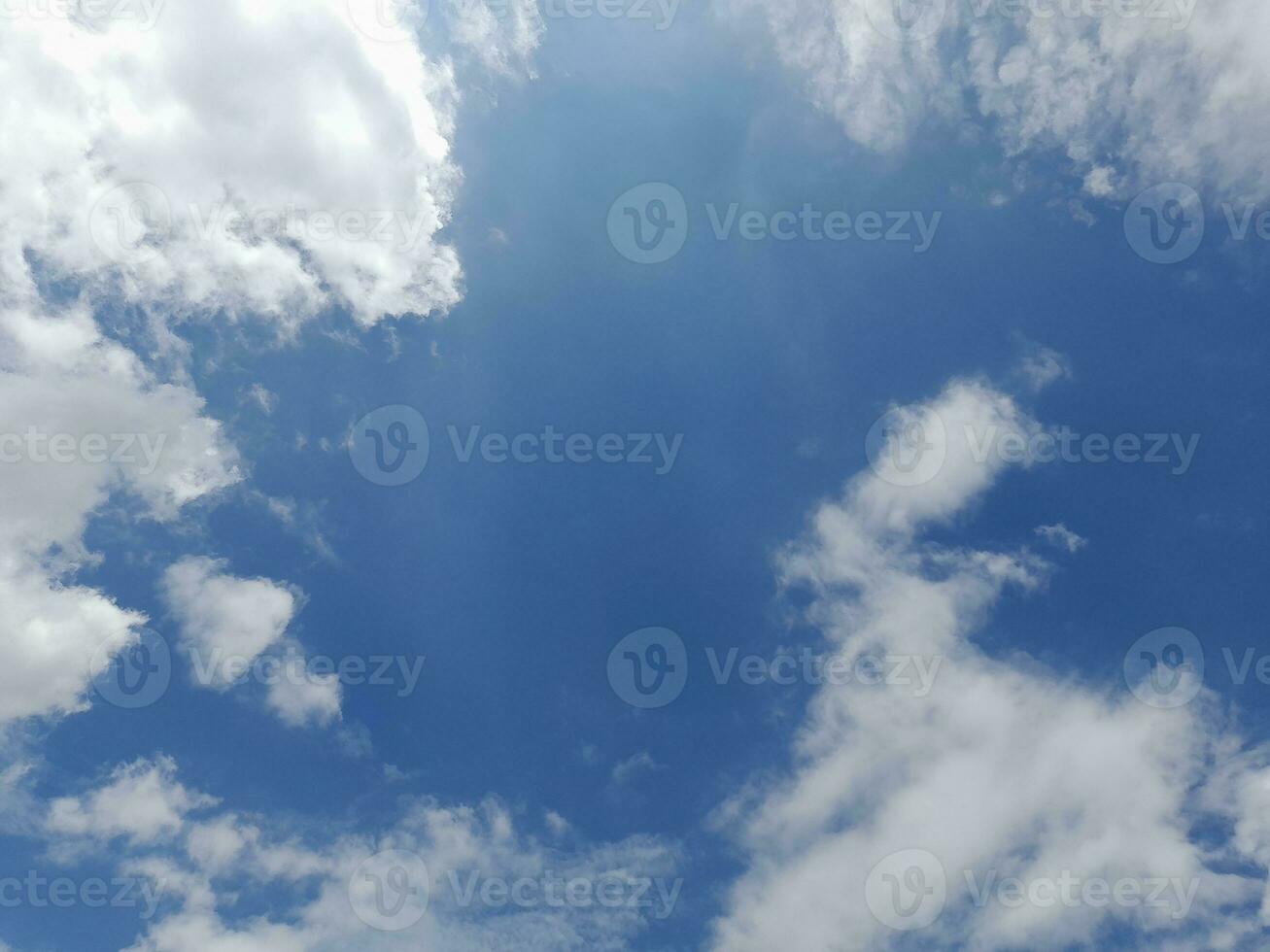 Beautiful white clouds on deep blue sky background. Large bright soft fluffy clouds are cover the entire blue sky. photo