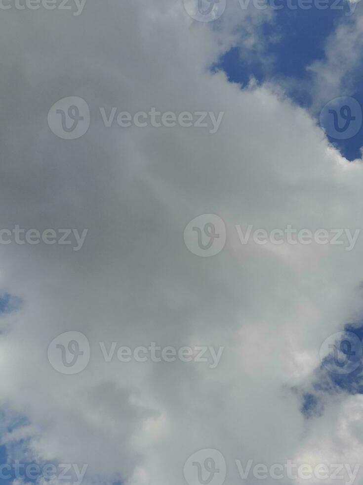 Beautiful white clouds on deep blue sky background. Large bright soft fluffy clouds are cover the entire blue sky. photo