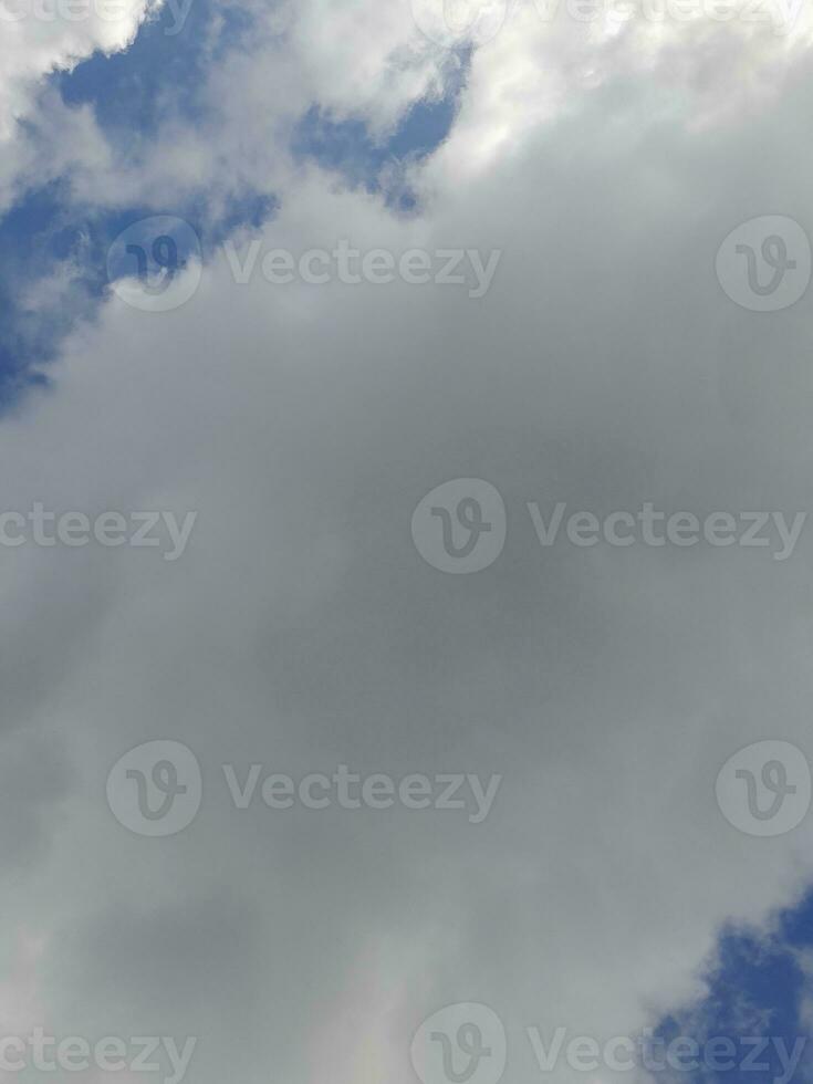 Beautiful white clouds on deep blue sky background. Large bright soft fluffy clouds are cover the entire blue sky. photo