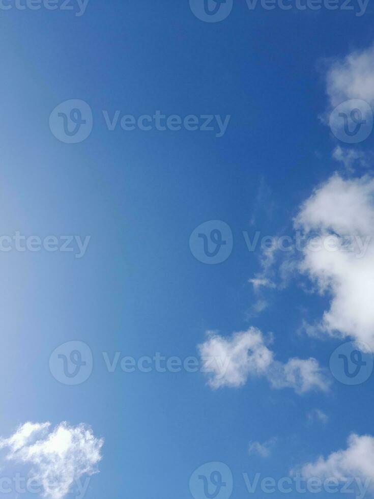 Beautiful white clouds on deep blue sky background. Large bright soft fluffy clouds are cover the entire blue sky. photo