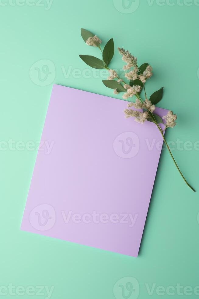 Top View of Blank Paper Card Mockup and Eucalyptus Floral Branch on Pastel Green Background, . photo