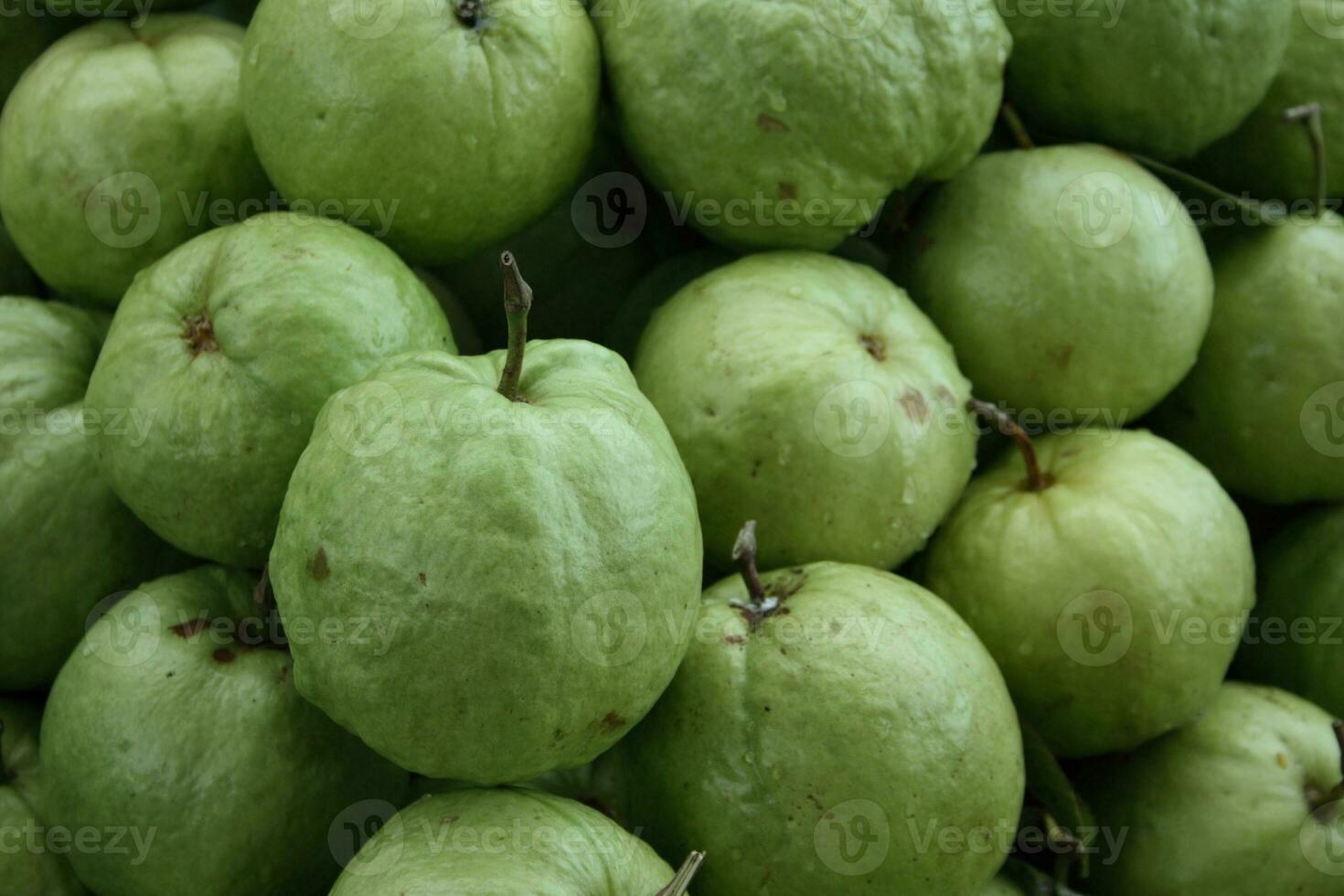 Stack of apple guavas on a market stall photo
