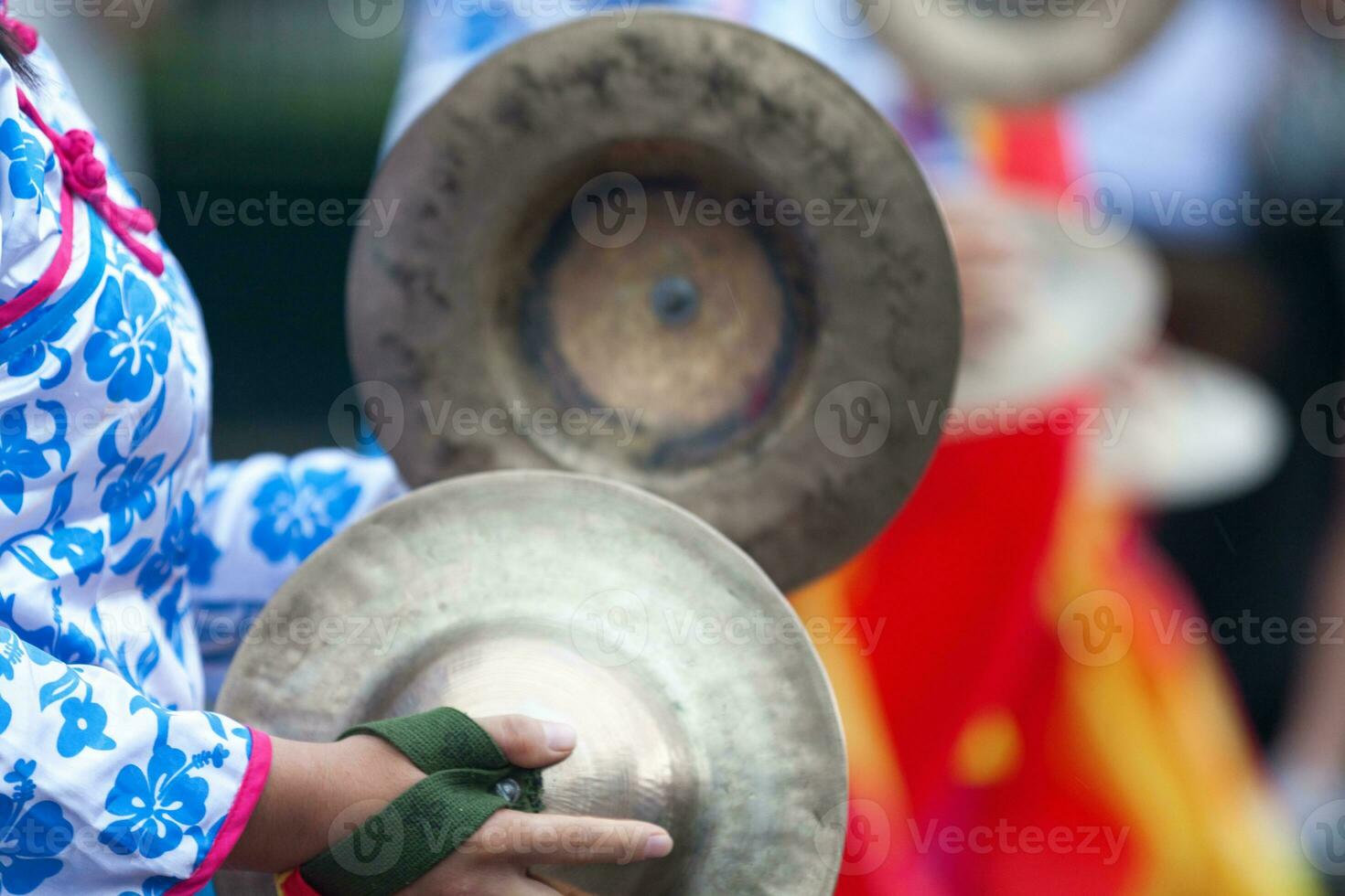 Musician playing with a pair of cymbals photo