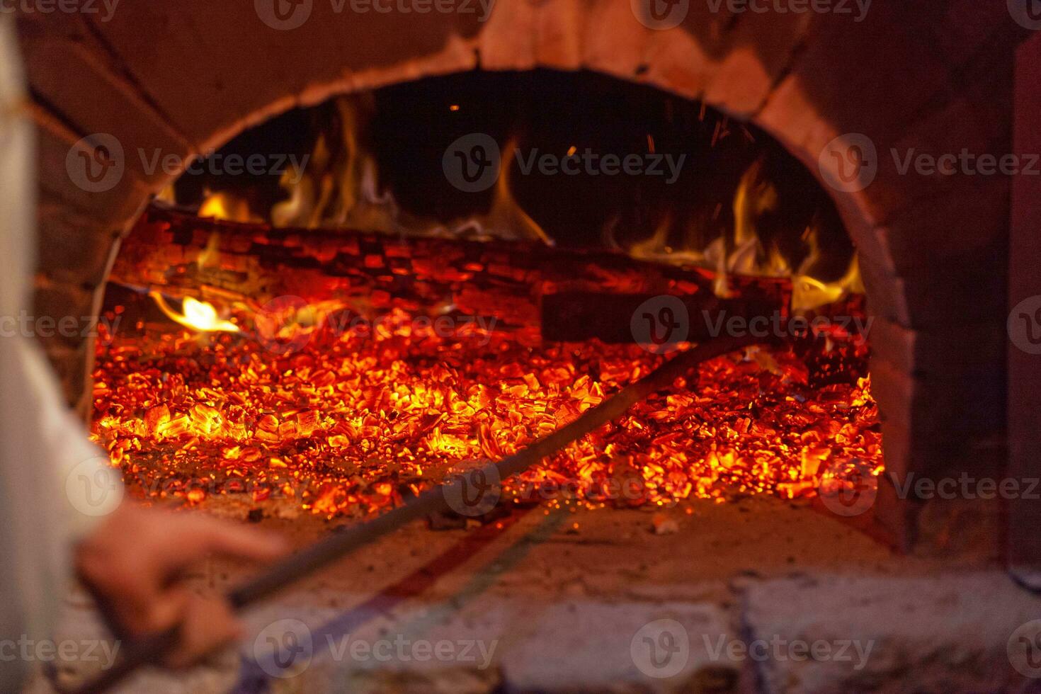 Baker making ready the brick oven photo