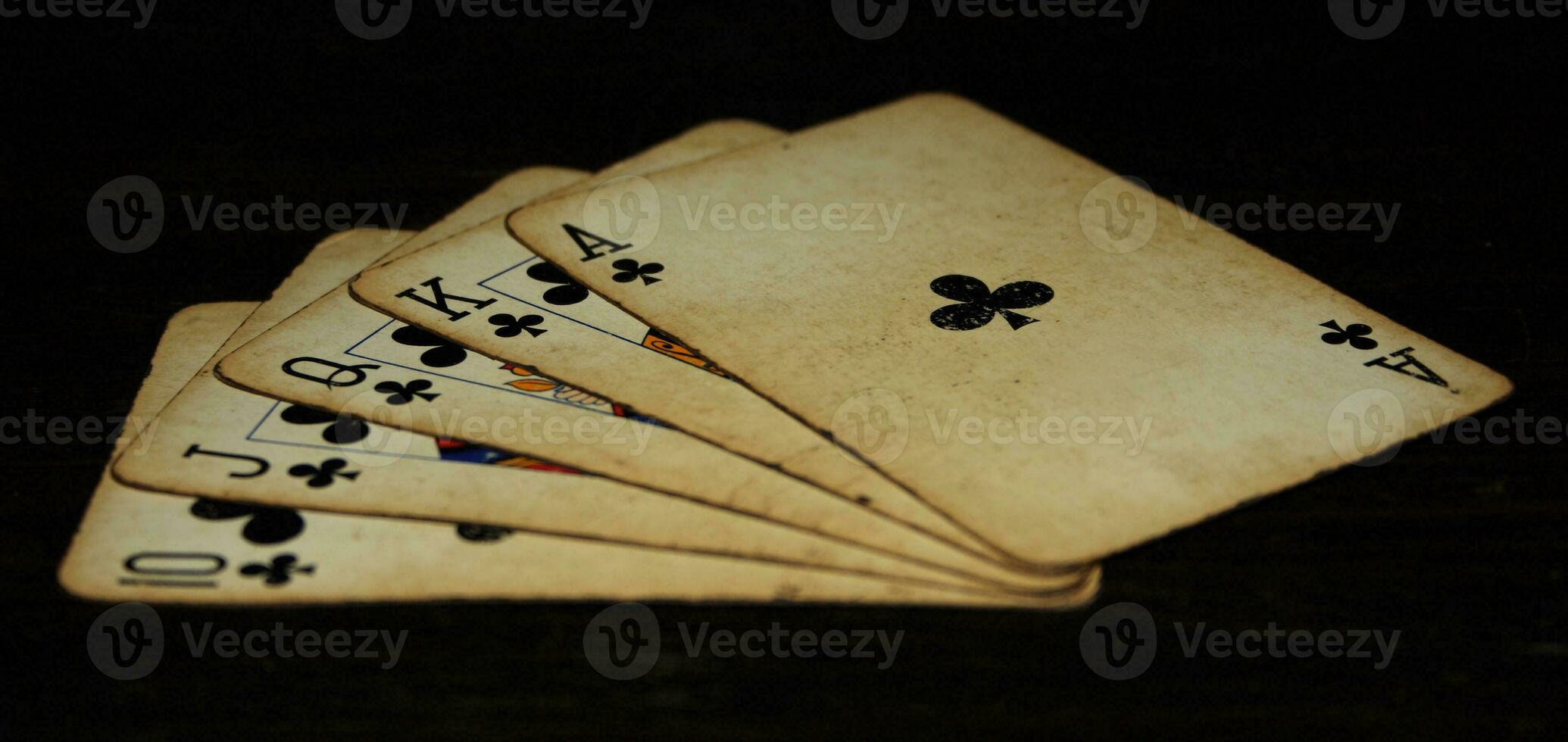 Royal flush of clubs on a black background photo