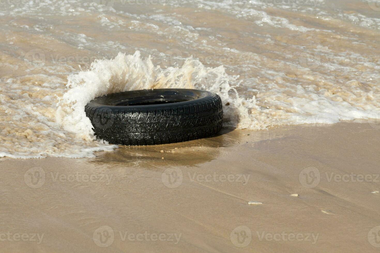 Beach pollution - Tire photo