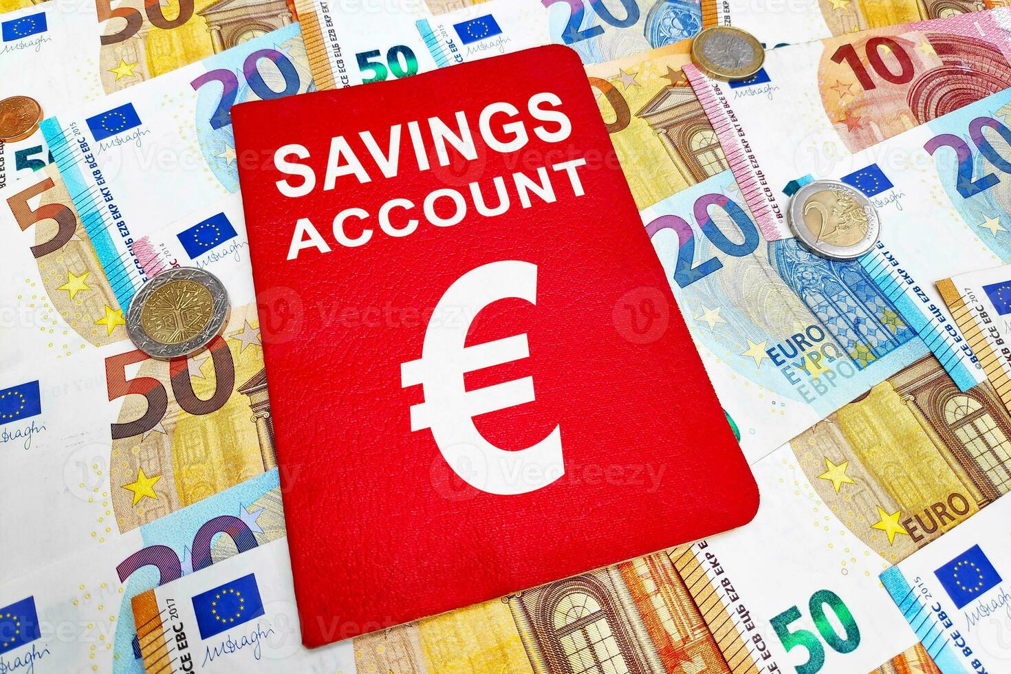 Savings account passbook atop of a stack of Euros photo