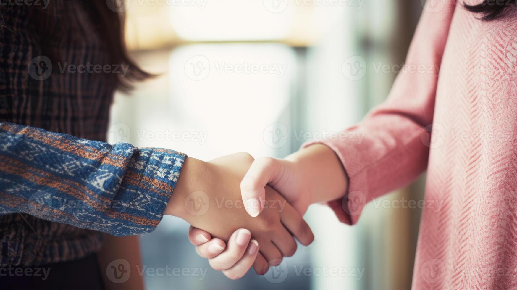 Friendly or casual handshake between two women. Close up. . photo