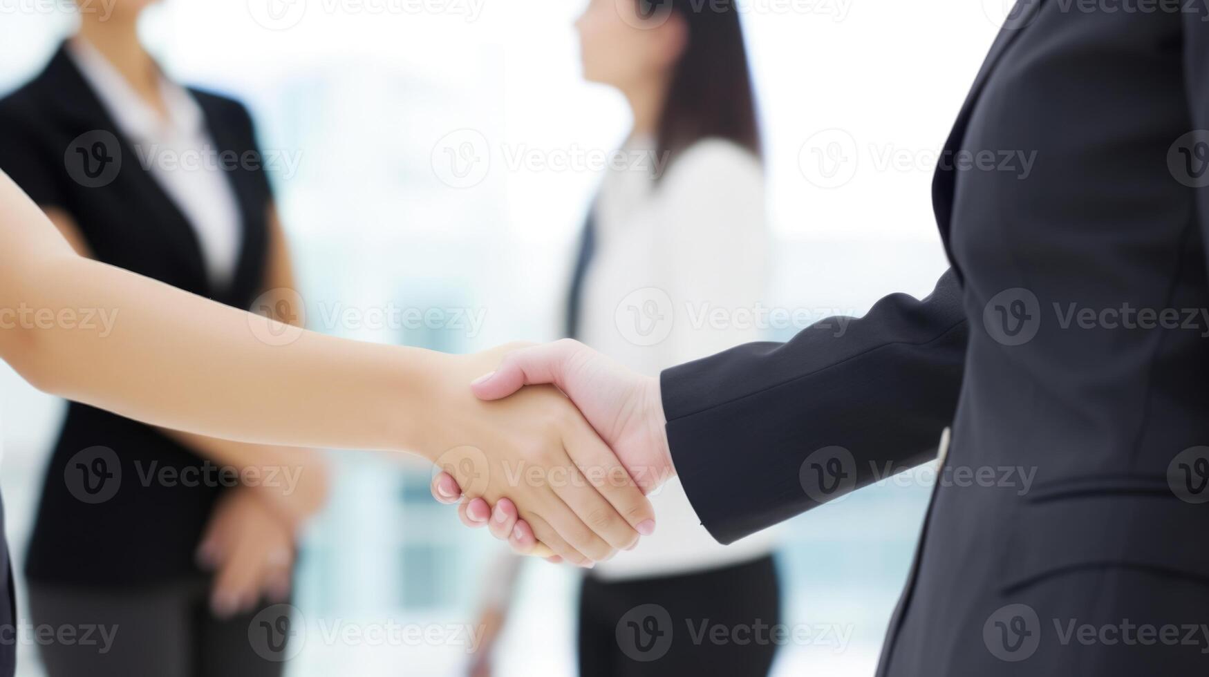 Business handshake between two women. Close up. Inside a modern bright office. . photo