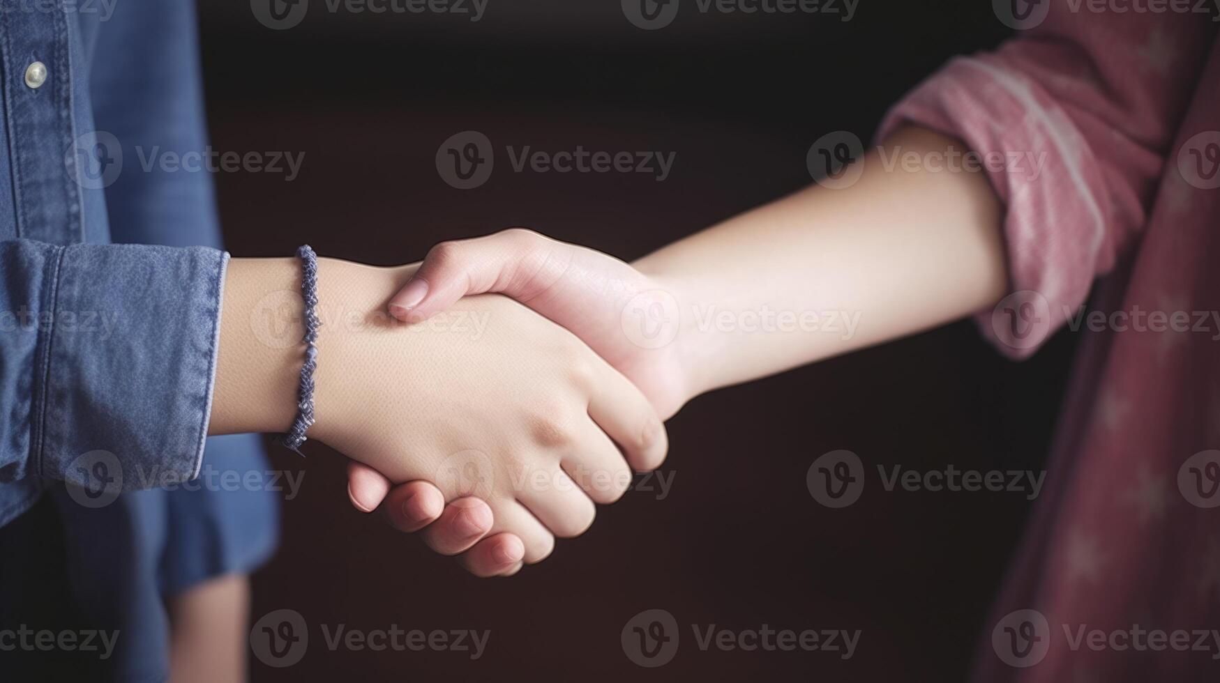 Friendly or casual handshake between two women. Close up. . photo