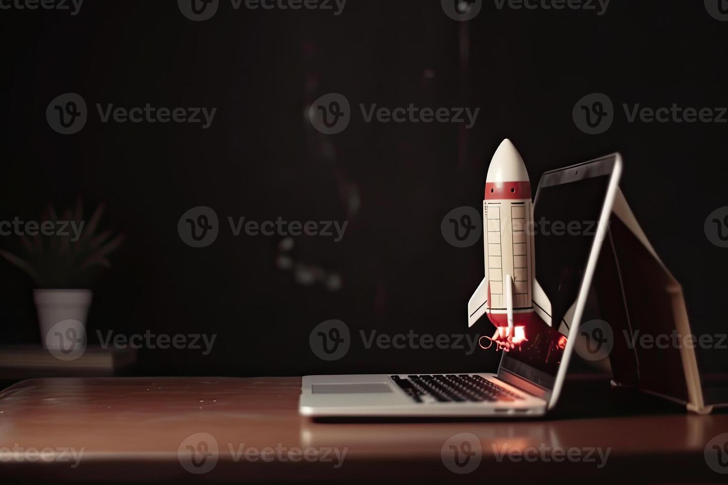 Rocket taking off from laptop screen on top of office desk, successful startup concept, photo