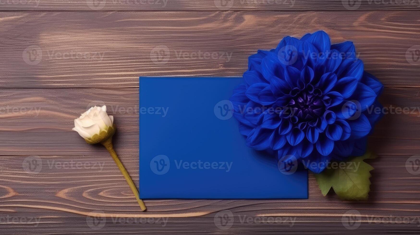 Blank Blue Paper Card Mockup with Dahlia Flower on Wooden Table Top, . photo